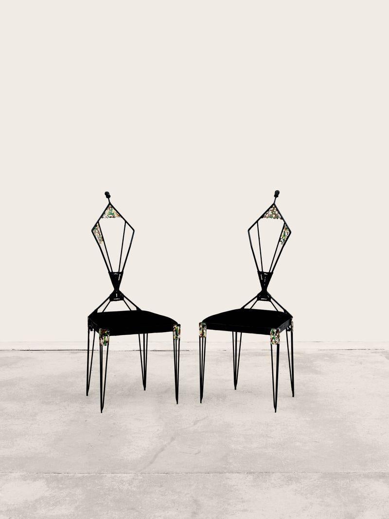Pair of iron chairs by the artist Ugo Trevisan (1904-?), with perforated iron decoration and carved face at the top of the seat, circa 1960, 120 x 60 x 60 cm.

The curved shape of the chair, which ends in a sculptural man's head, gives this pair