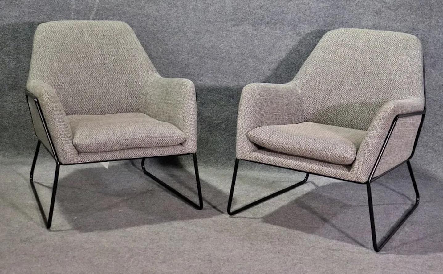 Pair of modern lounge chairs by Article with strong black iron frames and soft body.
Please confirm location NY or NJ