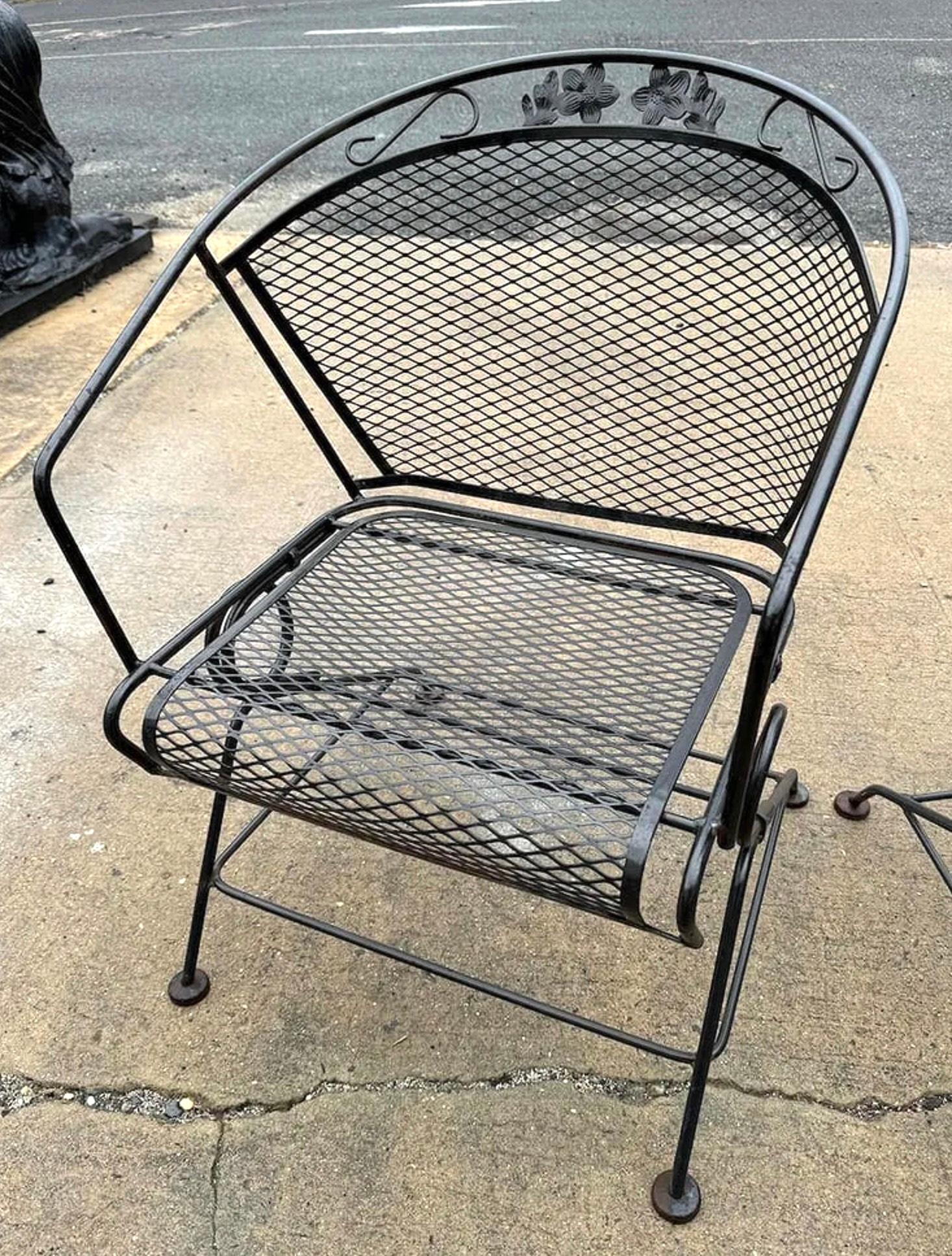 Pair of vintage iron patio chairs featuring spring-based rocking action for added comfort and relaxation. Designed with sturdy frames and classic lines, these chairs combine functionality with timeless outdoor style—perfect for a porch, patio, or