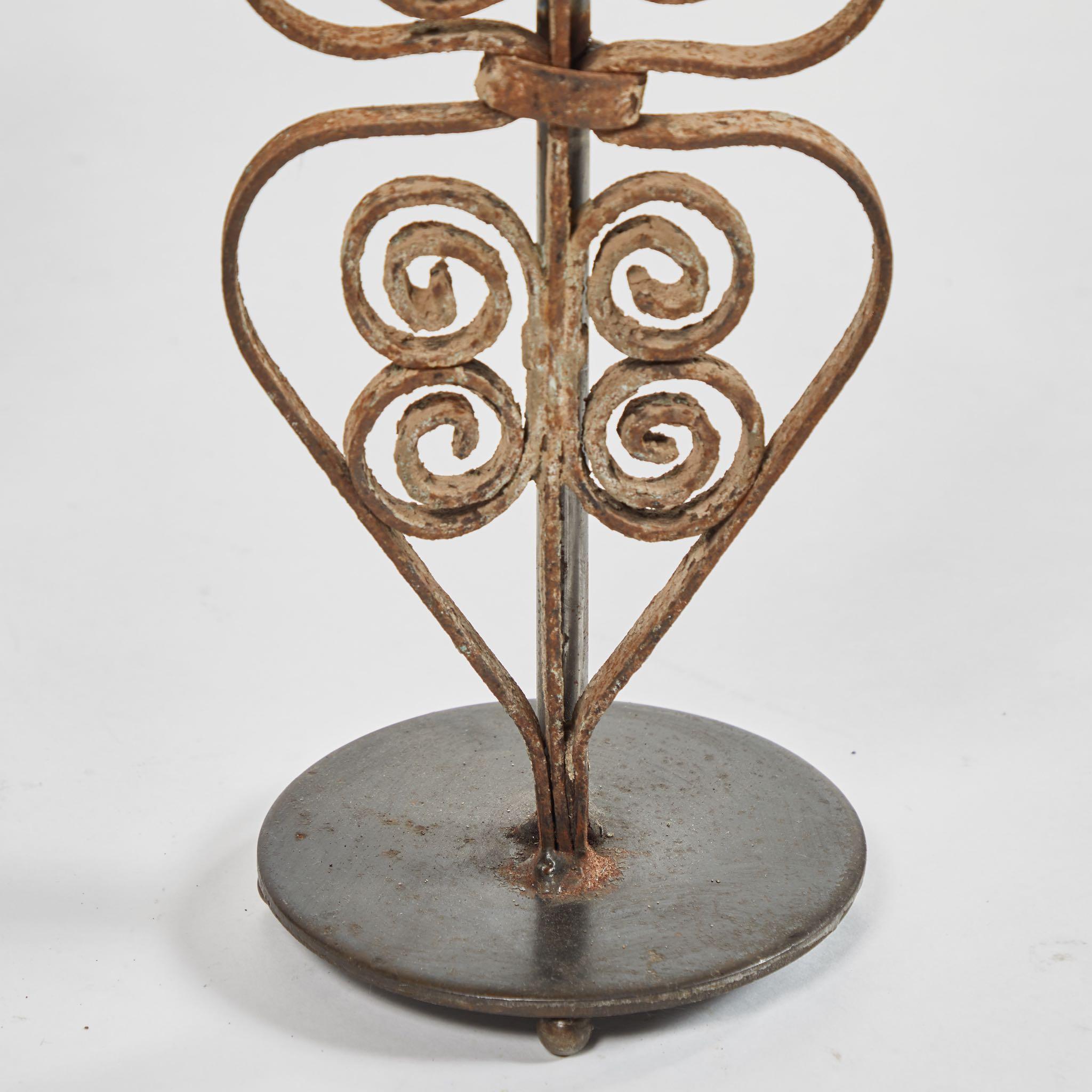 A pair of iron lamps, originating in England, circa 1880.