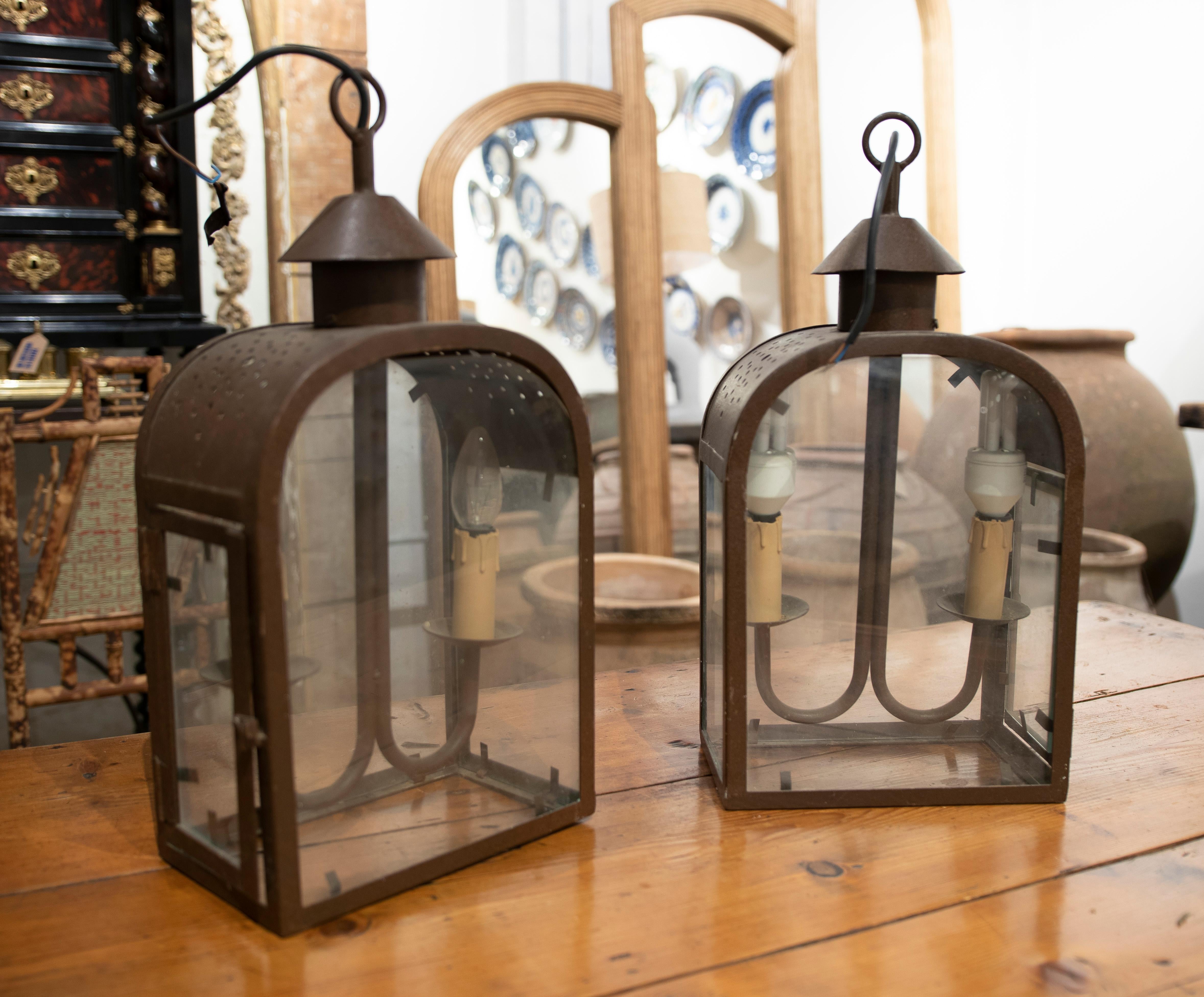 Pair of iron lanterns with rust brown finish crystals.