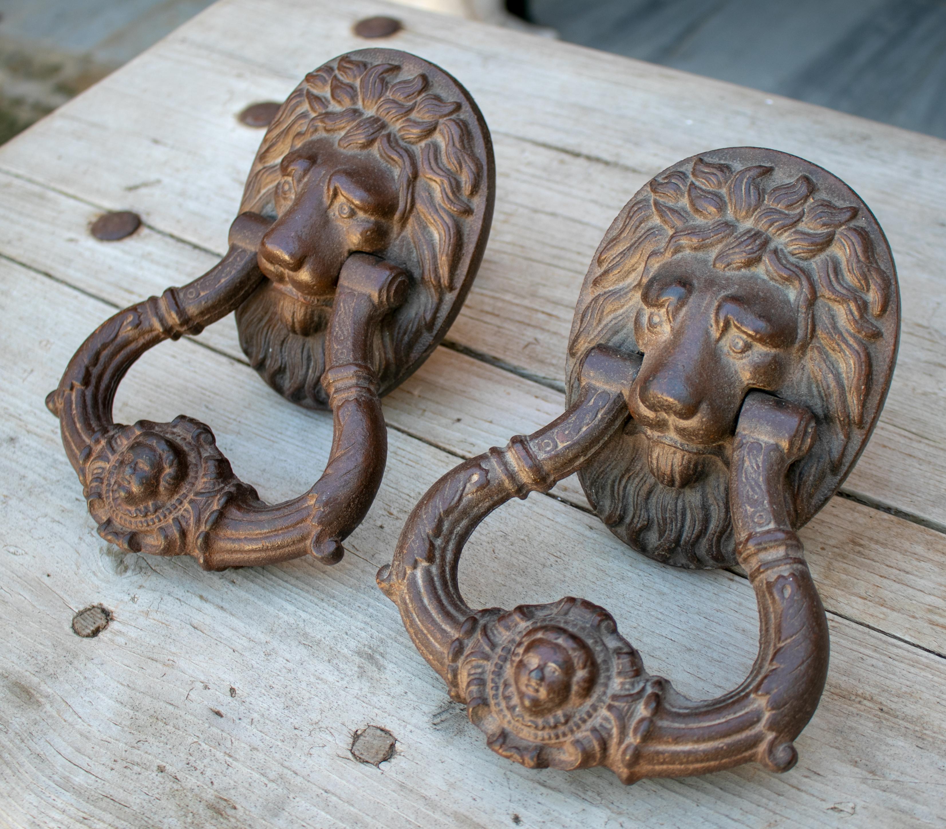 Pair of iron lion heads door knokers from 19th century.