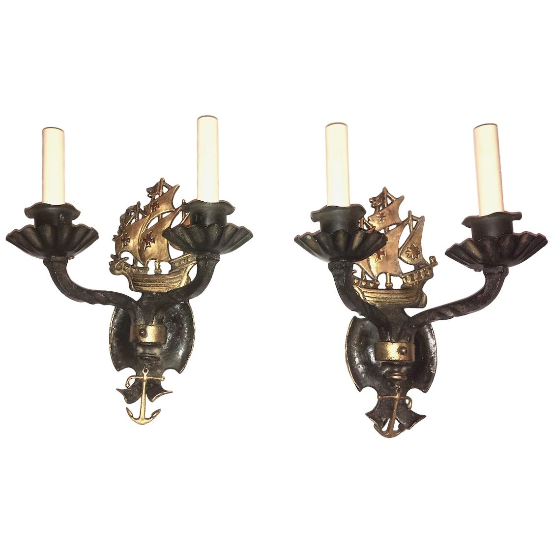 A pair of circa 1920’s American cast iron sconces with original painted finish, decorated with sail ships and anchors.

Measurements:
Height: 13″
Depth: 6″
Width: 10″