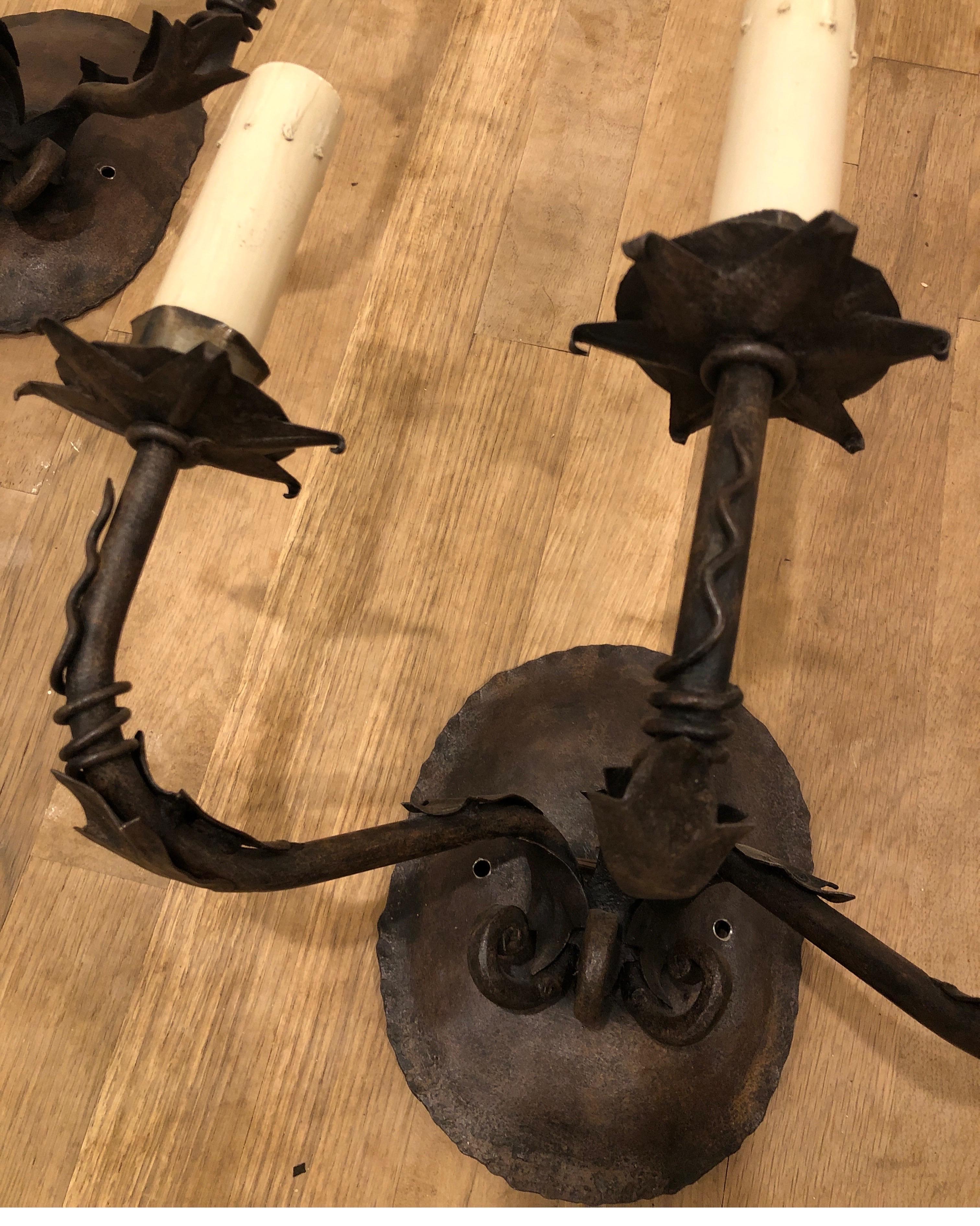 Pair of Paul Ferrante iron wall sconces. Triple arms with 6 point star under each candle stick. 
Three faux candle melt covers.

See images for details.