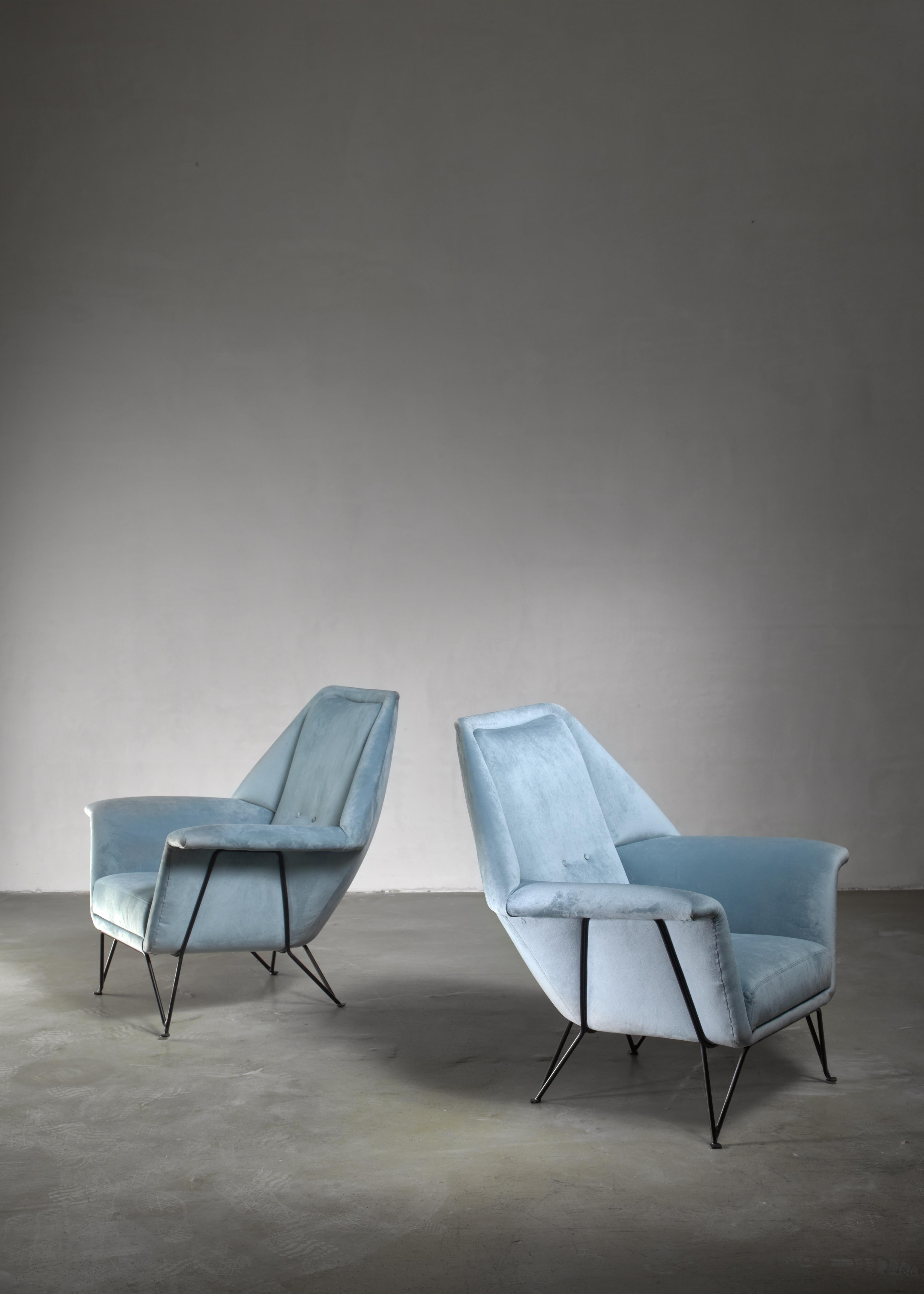 A pair of lounge chairs by Giulia Veronesi for I.S.A. Bergamo. The chairs are in perfect condition and have a new, light blue upholstery and Stand on a thin, black metal frame.