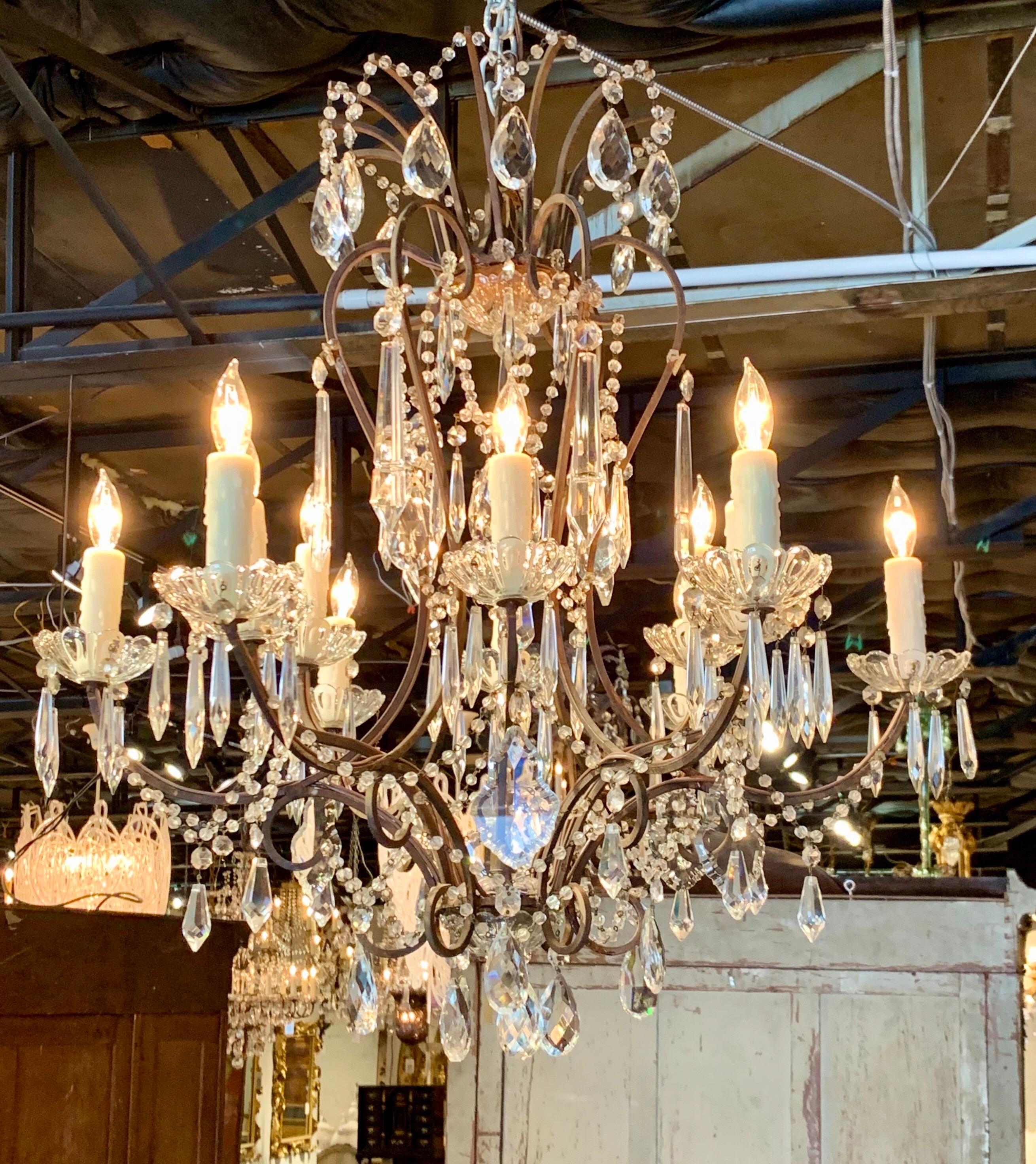 Gorgeous pair of Italian 12-light beaded crystal chandeliers. A lovely array of crystals, beads and prisms along with a beautiful base. A fabulous pair and very fine quality!