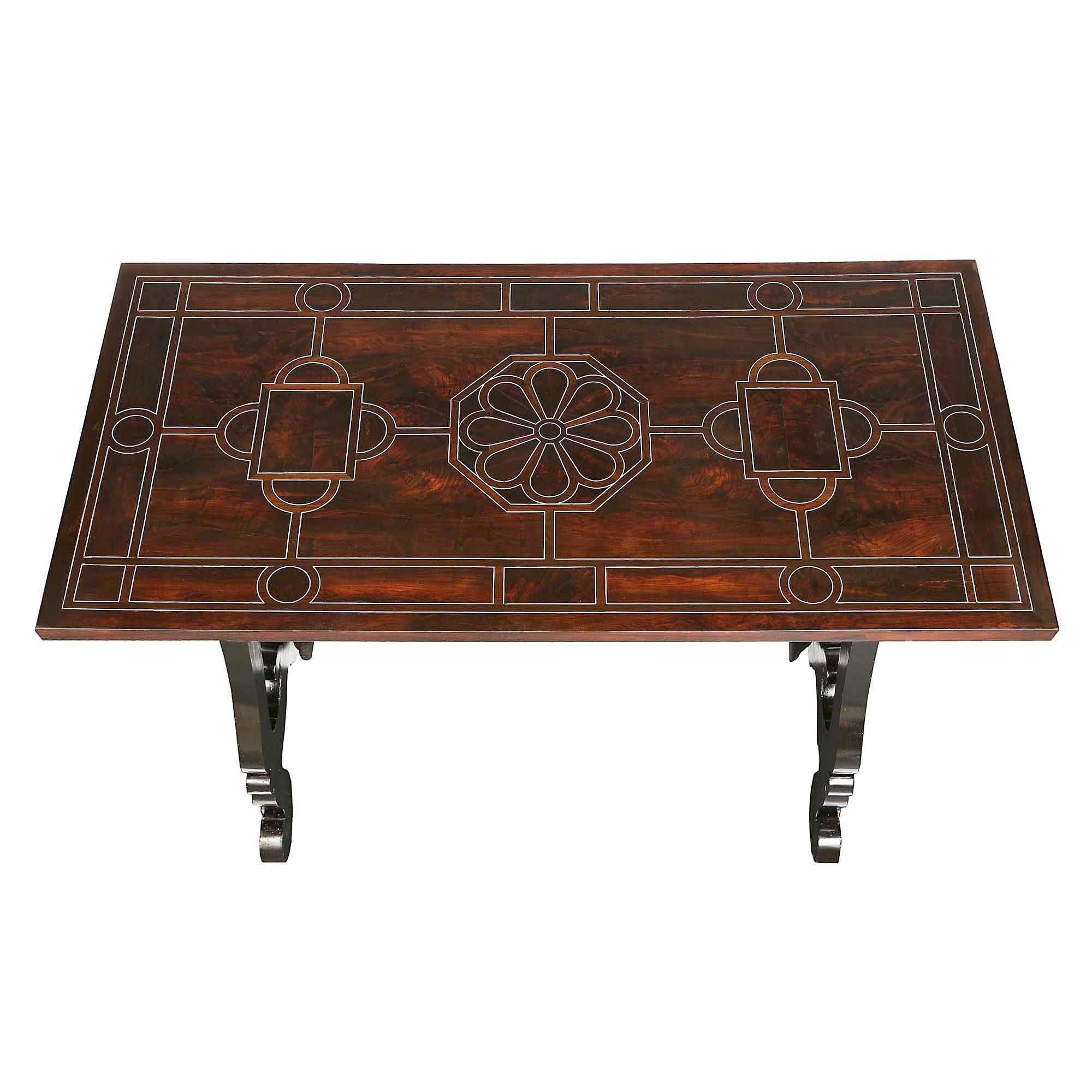 A rare and stunning pair of Italian 17th century rosewood and ebonized fruitwood trestle tables from Florence. The outstanding tables are raised by handsome scrolled ebonized fruitwood supports connected by impressive original hand beaten wrought