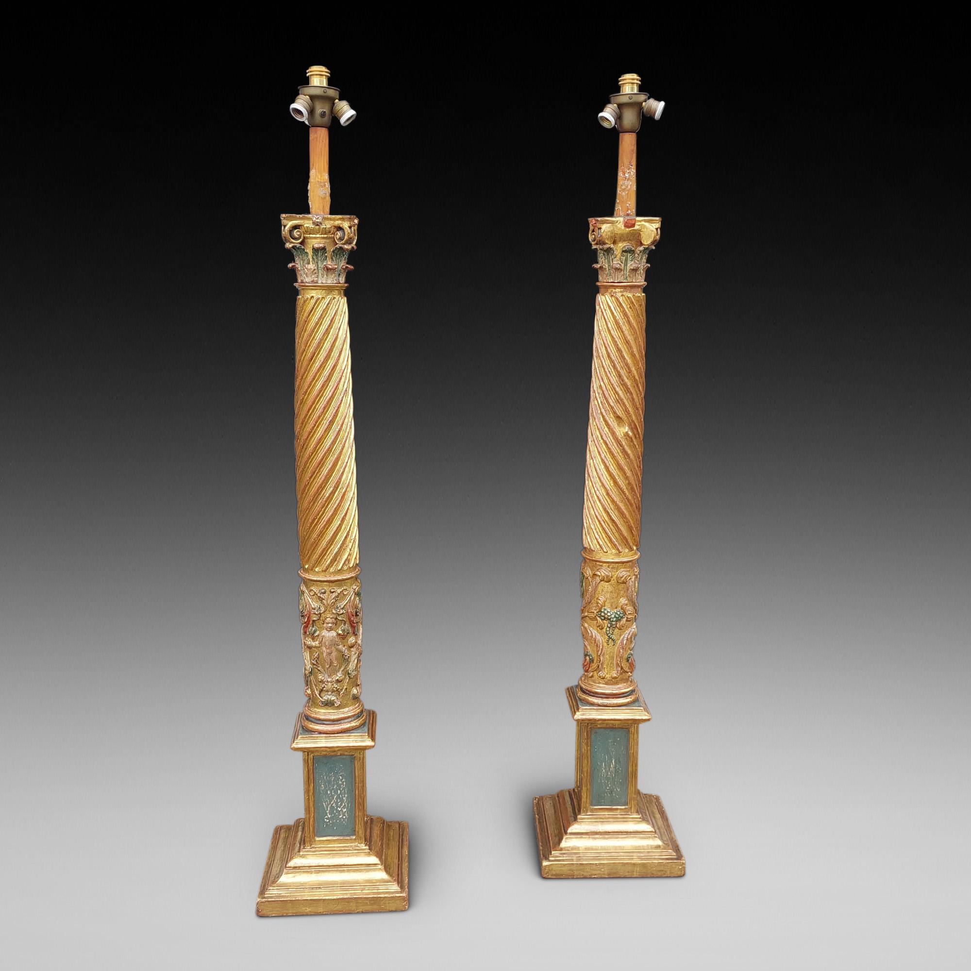 Pair of Italian 17thC Polychrome & Gilt Highlighted Carved Corinthian Columns with barley twist centres and Putti decoration standing on later square moulded plinth bases - later fitted for electric - 22