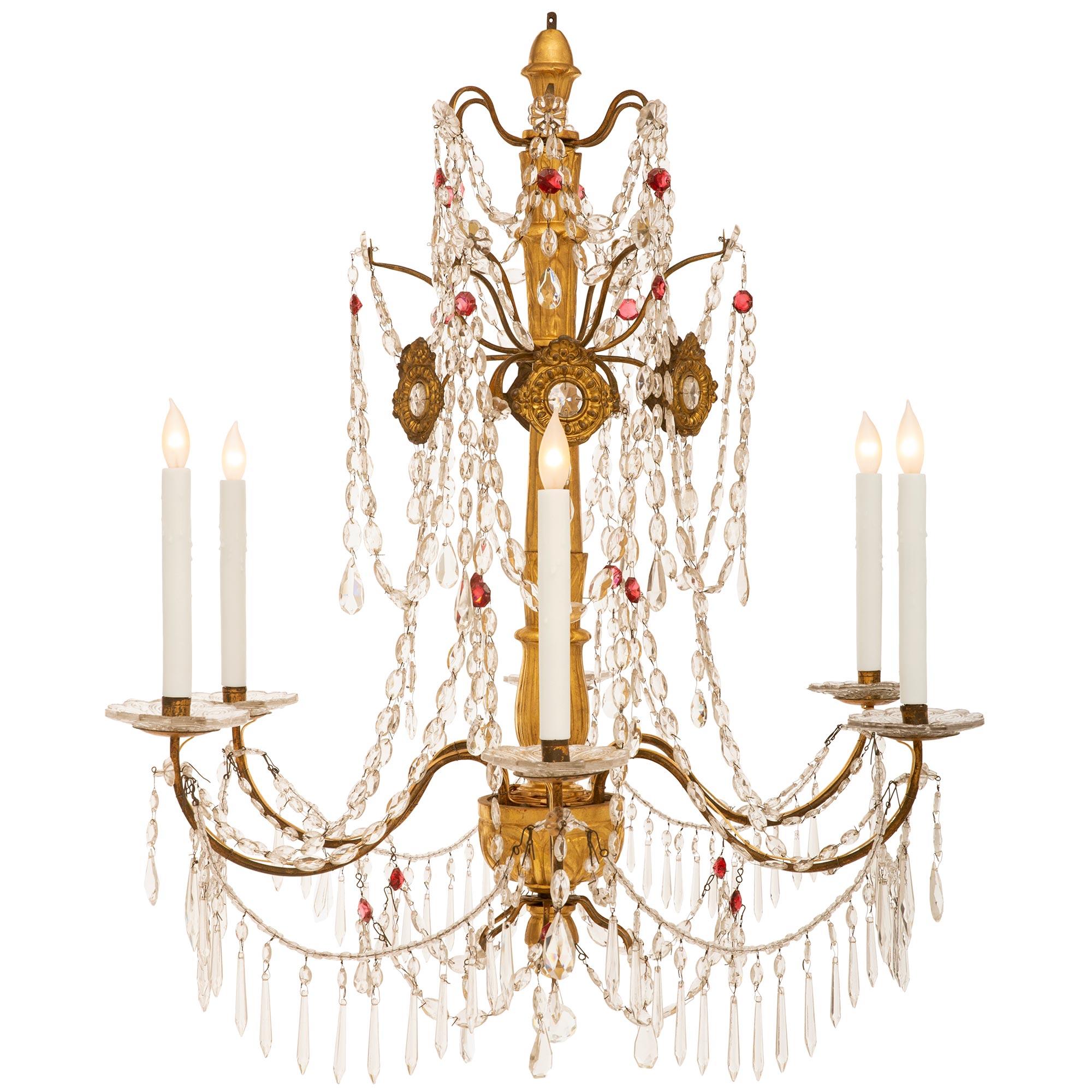 A beautiful and very elegant pair of Italian 18th century Genovese st. Giltwood, glass, Iron and Crystal chandeliers. Each six arm chandelier is centered by a lovely bottom Giltwood acorn finial surrounded by charming crystal pendants. The elegantly