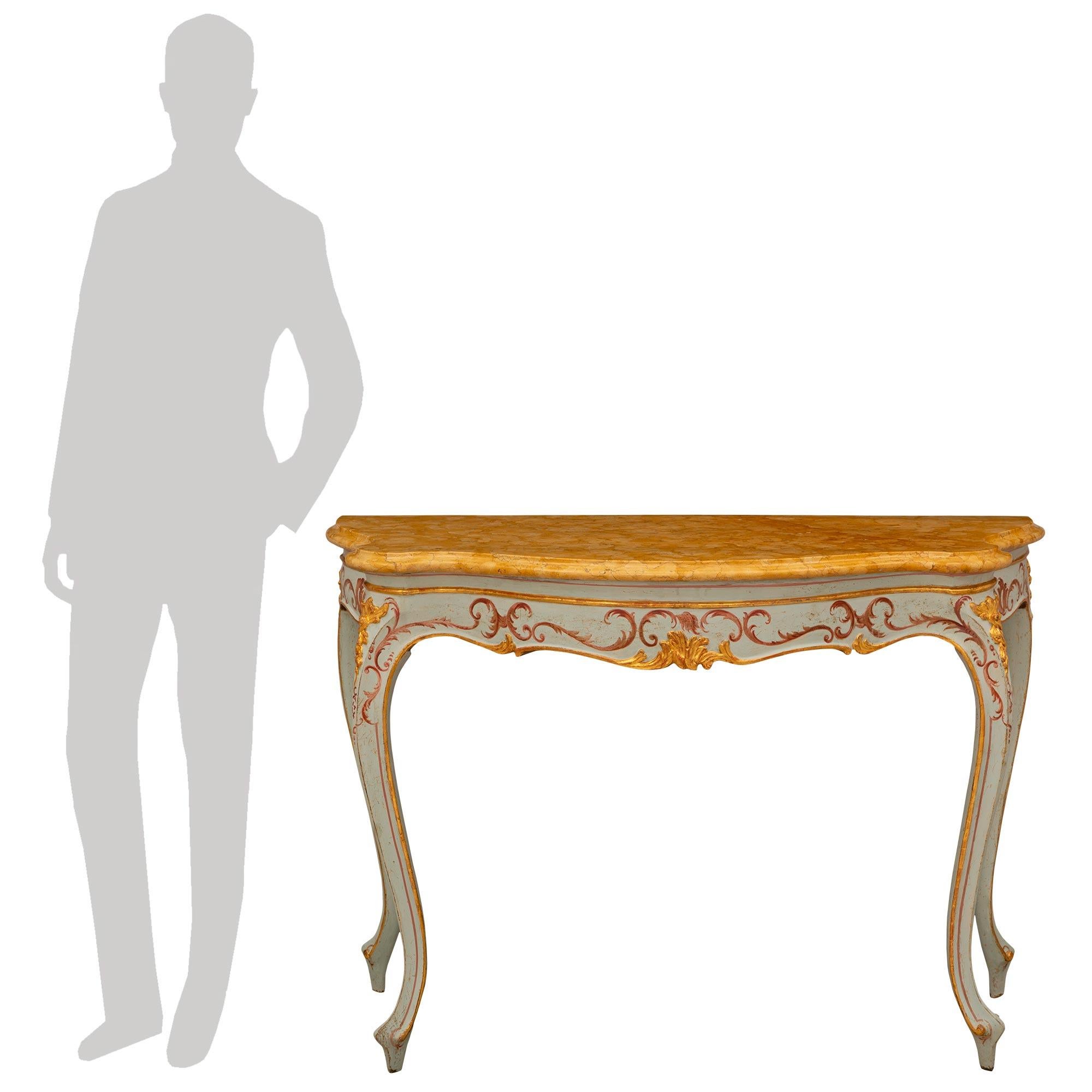 A beautiful and most decorative pair of Italian 18th century Venetian st. Giltwood, patinated wood and Sienna marble consoles. Each freestanding console is raised by elegant Giltwood cabriole legs with scrolled feet, superb hand painted designs, and
