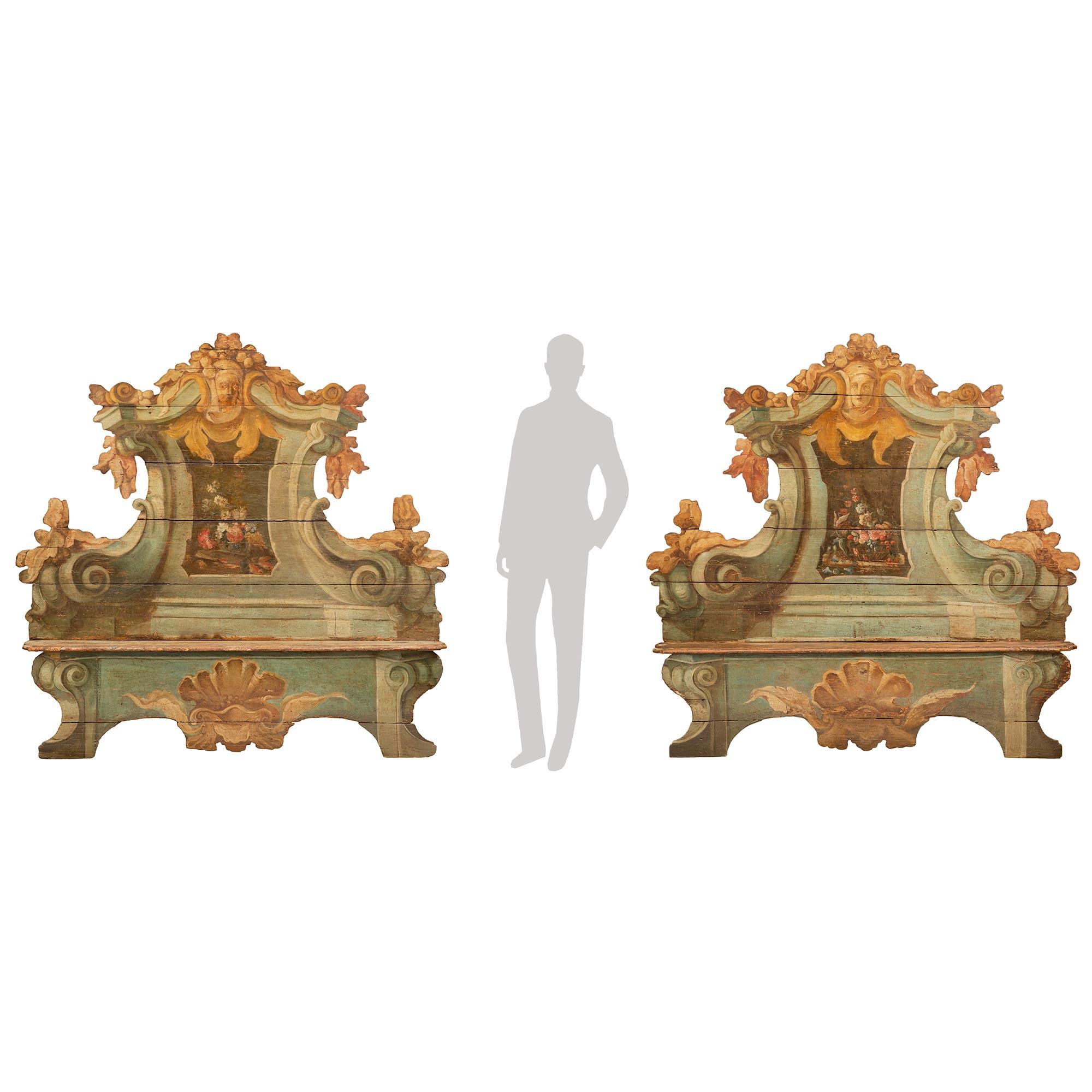 A sensational and large scale pair of Italian 18th century Baroque Cassapanca polychrome benches. Each beautiful and statement making bench is raised by elegant curved supports with striking hand painted scrolled designs and finely detailed central