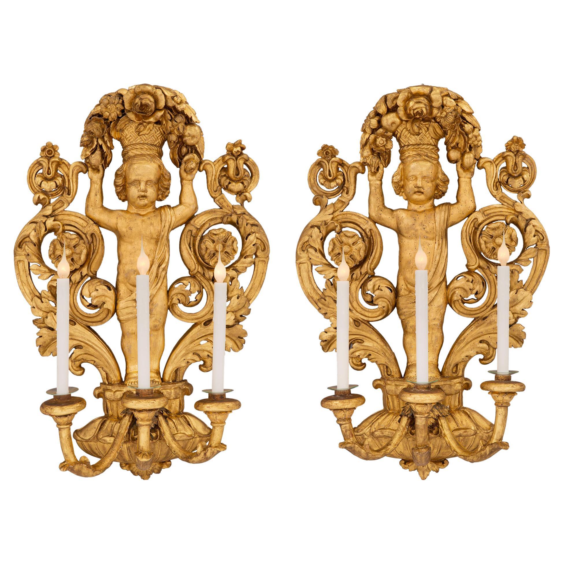 Pair of Italian 18th Century Baroque Period Giltwood Three-Arm Sconces For Sale