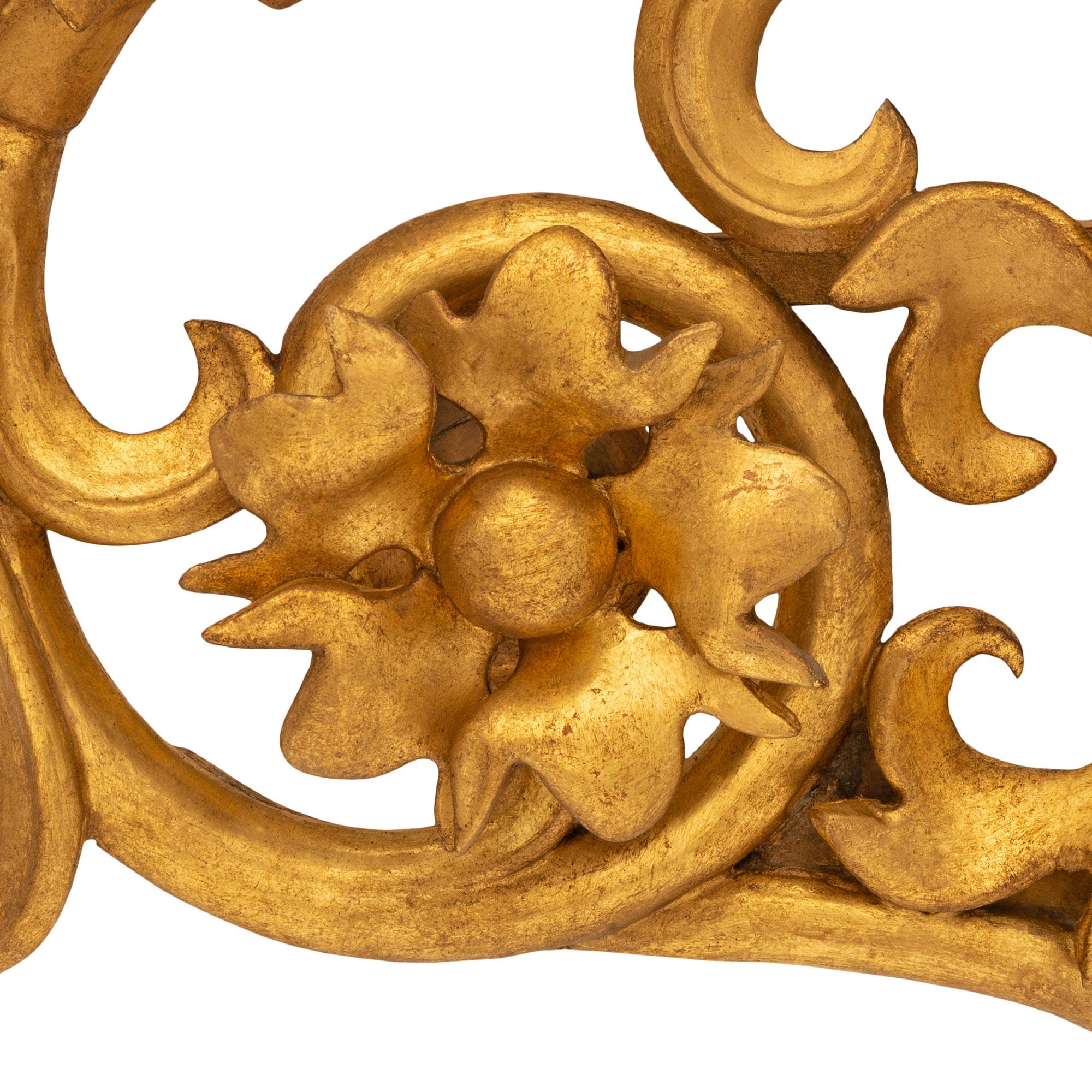 A very decorative pair of Italian 18th century Baroque st. Giltwood wall decor. Each pierced wall decor has a central double acanthus leaf with two 'C' and 'S' scrolled foliate branches which protrude outwards and join at the top. The bottom 'C'