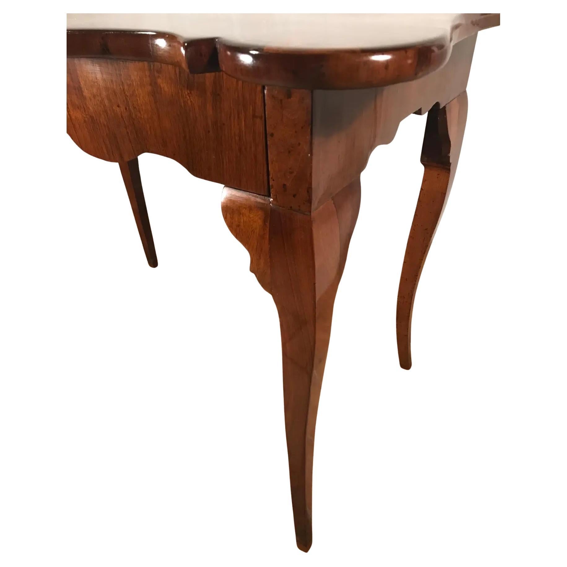Pair of Italian console tables, Northern Italy 18th century, walnut veneer. Exquisite and rare pair of console tables which were probably made in the Veneto region. The curved tops, which are embellished with mirrored walnut veneer, are raised on