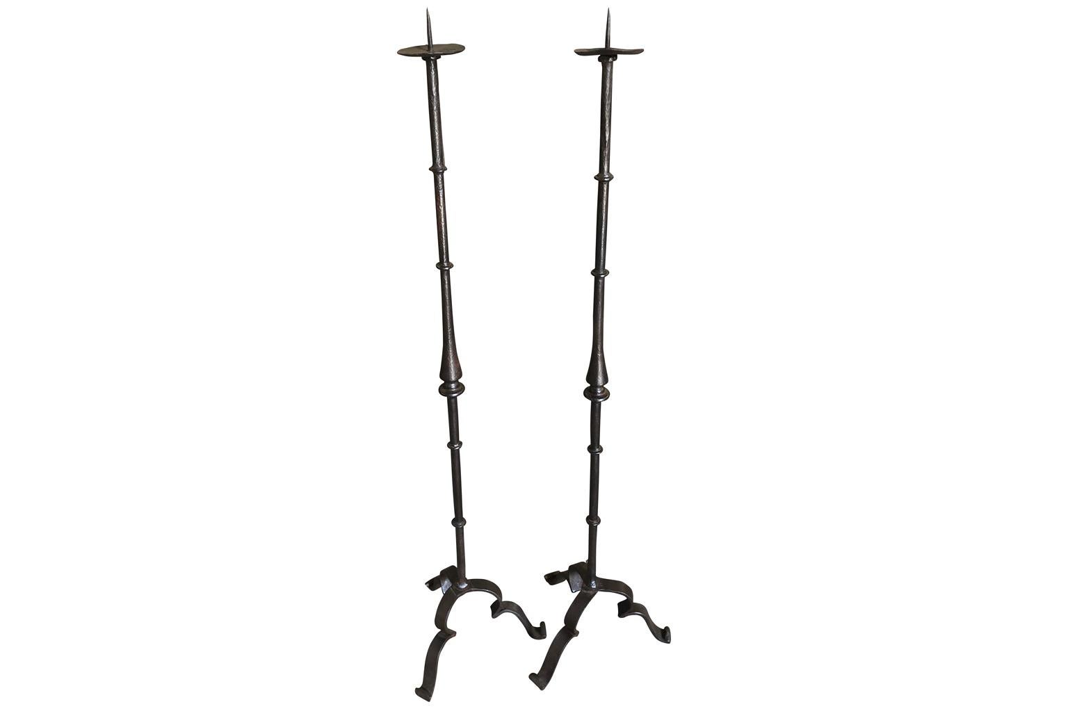 A very handsome pair of late 18th century Italian Torcheres. Beautifully fashioned from hand forged iron. Wonderful for candles or electrified as floor lamps.