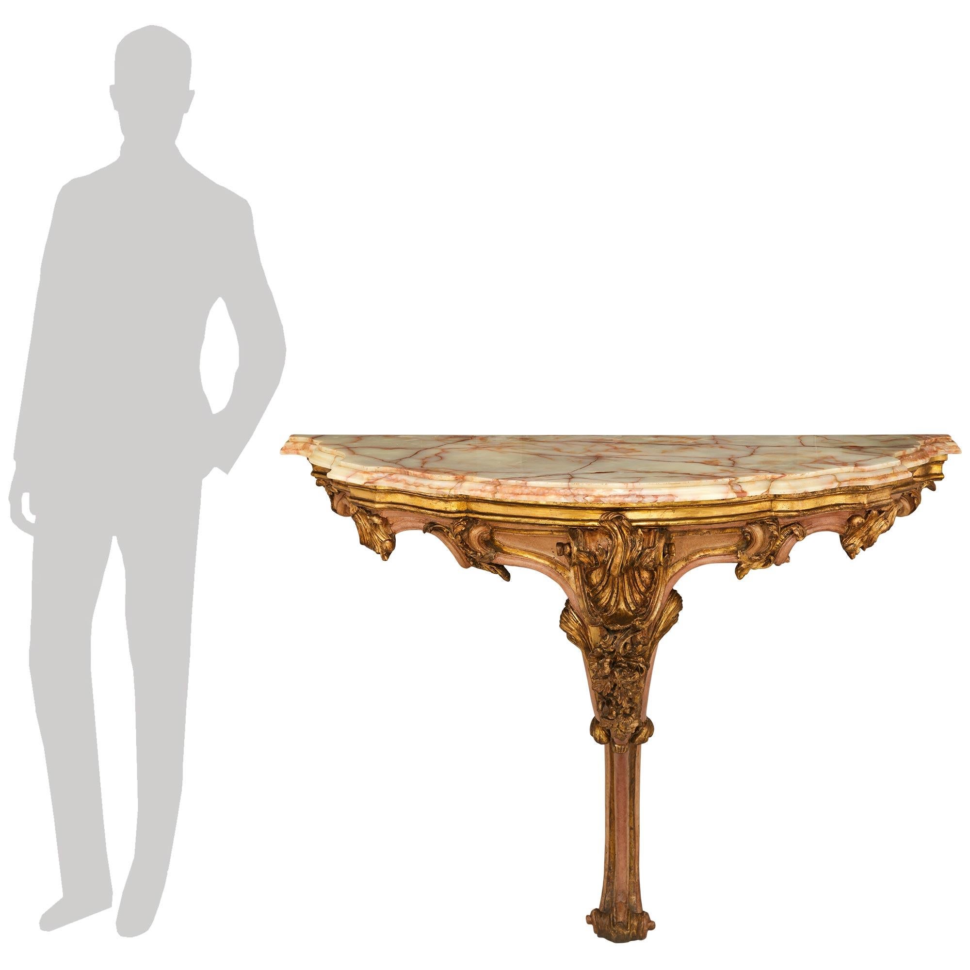 A sensational and extremely high quality pair of Italian late 18th century Louis XV st. patinated Wood, Mecca and Onyx consoles. This impressive and large scale pair of demi lune shaped consoles are raised on single scrolled and mottled foliate legs