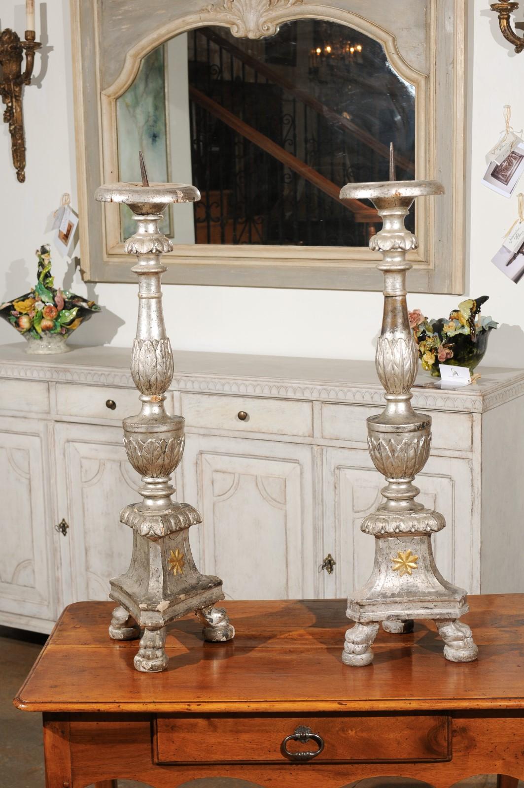 A pair of Italian 18th century tall silver gilt candlesticks prickets with waterleaf motifs and gold gilt star. Born in Italy during the 18th century, each of this exquisite pair of silver gilt candlesticks features a hand carved stem, adorned with