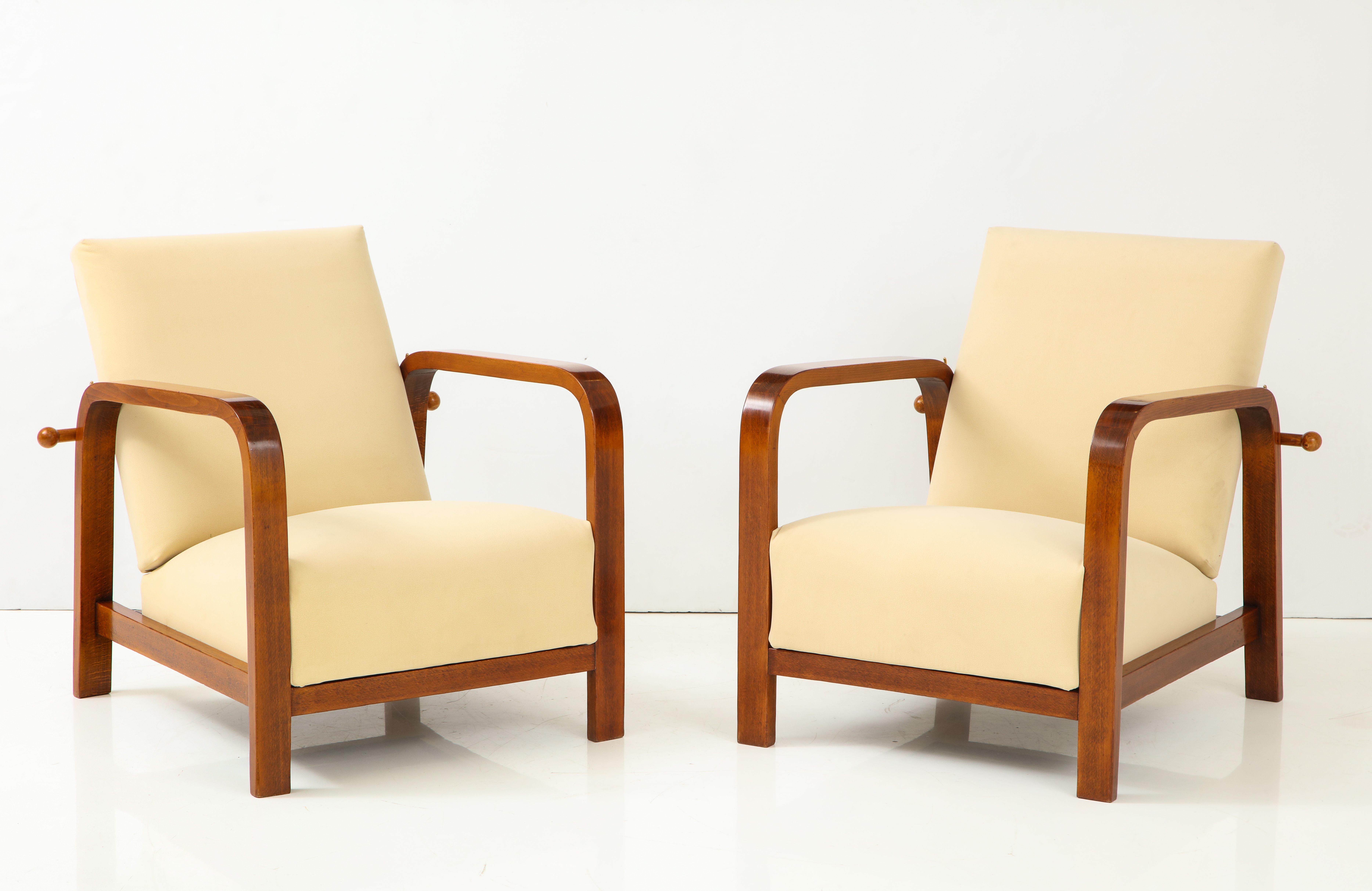 Pair of Italian 1930s palisander wood armchairs with adjustable reclining backs; the back with turned wood bar and brass fitting for reclining at three levels; newly upholstered in tan suede.
Italy, circa 1930.
Size: 15 1/2” seat height x 32 1/2”