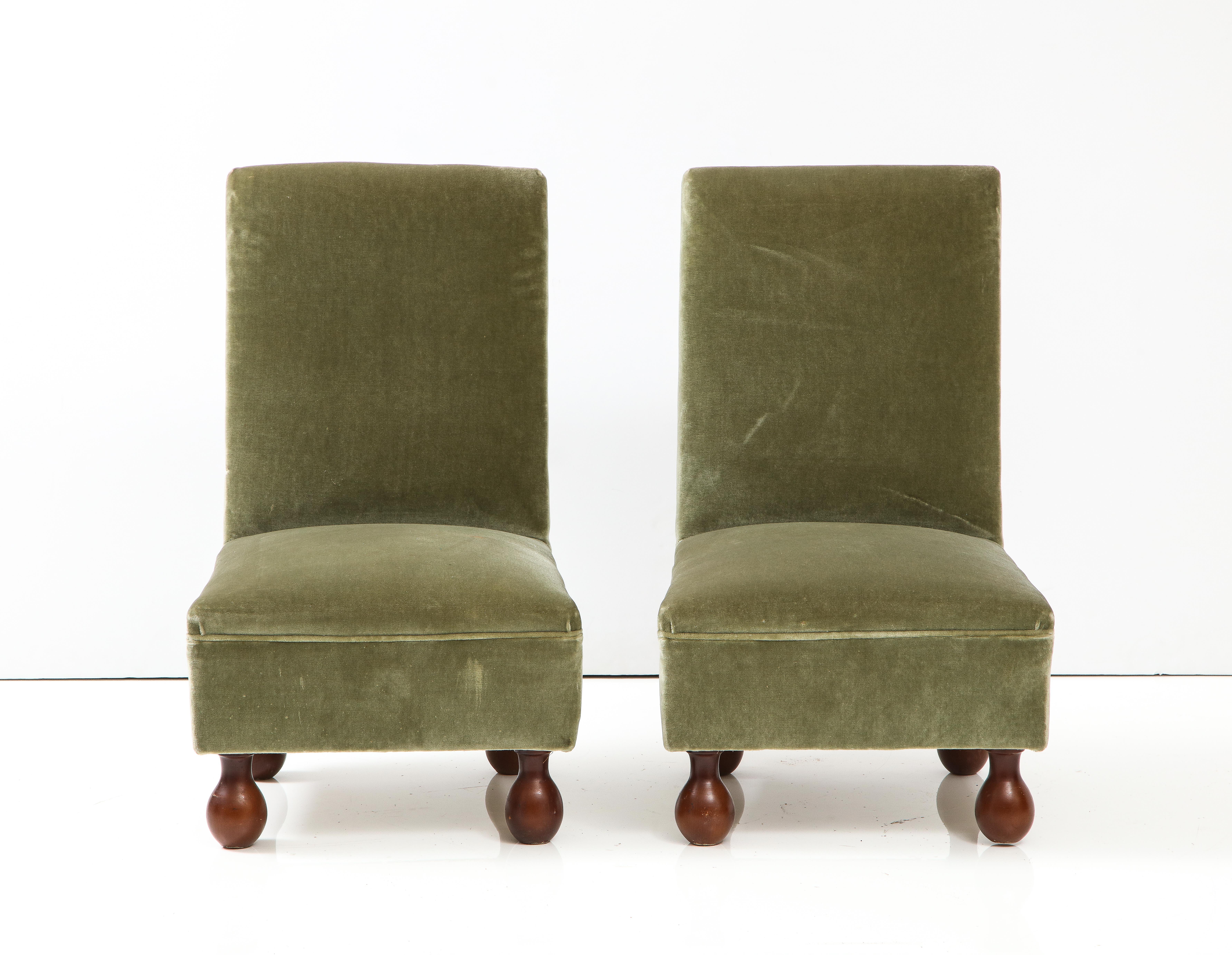 A charming pair of Italian 1940's slipper chairs, upholstered in their original seafoam green velvet, the whole supported on walnut bun feet. 
Northern Italy, circa 1940 
Size: 31 3/4
