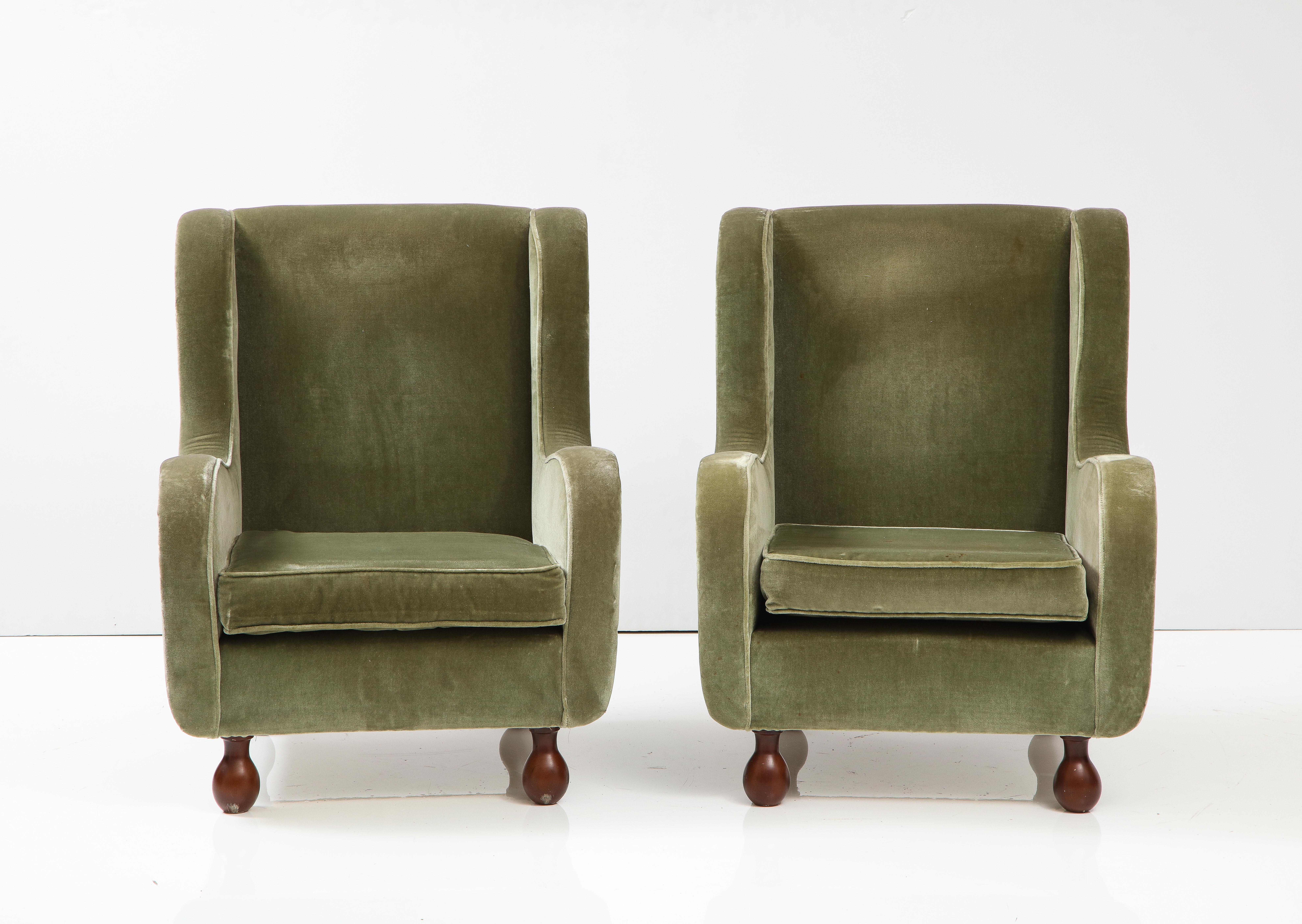 A charming pair of Italian 1940's armchairs, upholstered in their original seafoam green velvet, with beautifully curved arms, rectangular backs; the whole supported on walnut bun feet. Also available: a pair of slipper chairs and settee. 
Northern