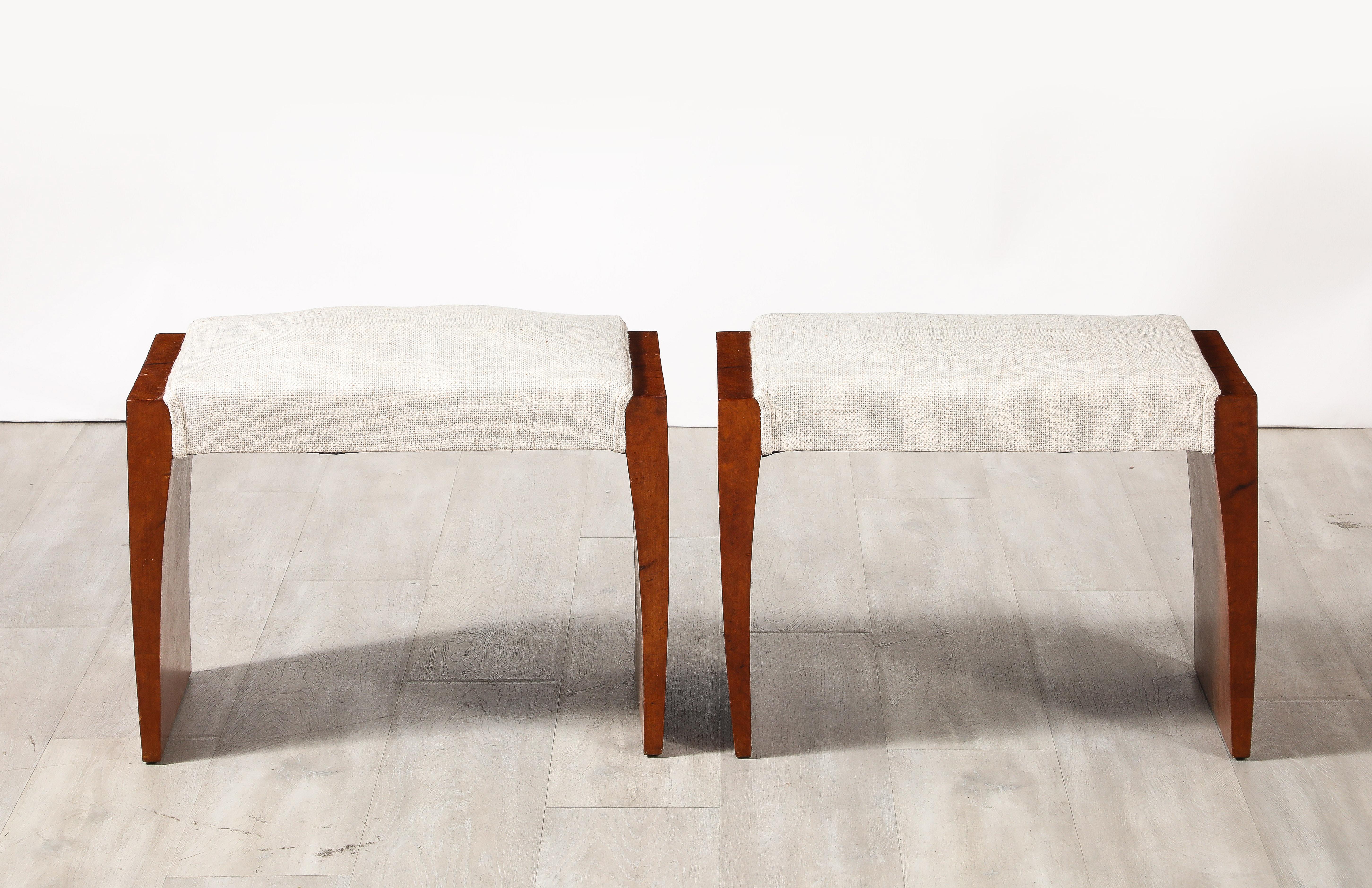 A pair of fine Italian 1950's briar wood stools, the legs elegantly tapered.  The seat newly upholstered in a cream colored linen. 
Italy, circa 1950 
Size: 17 1/2