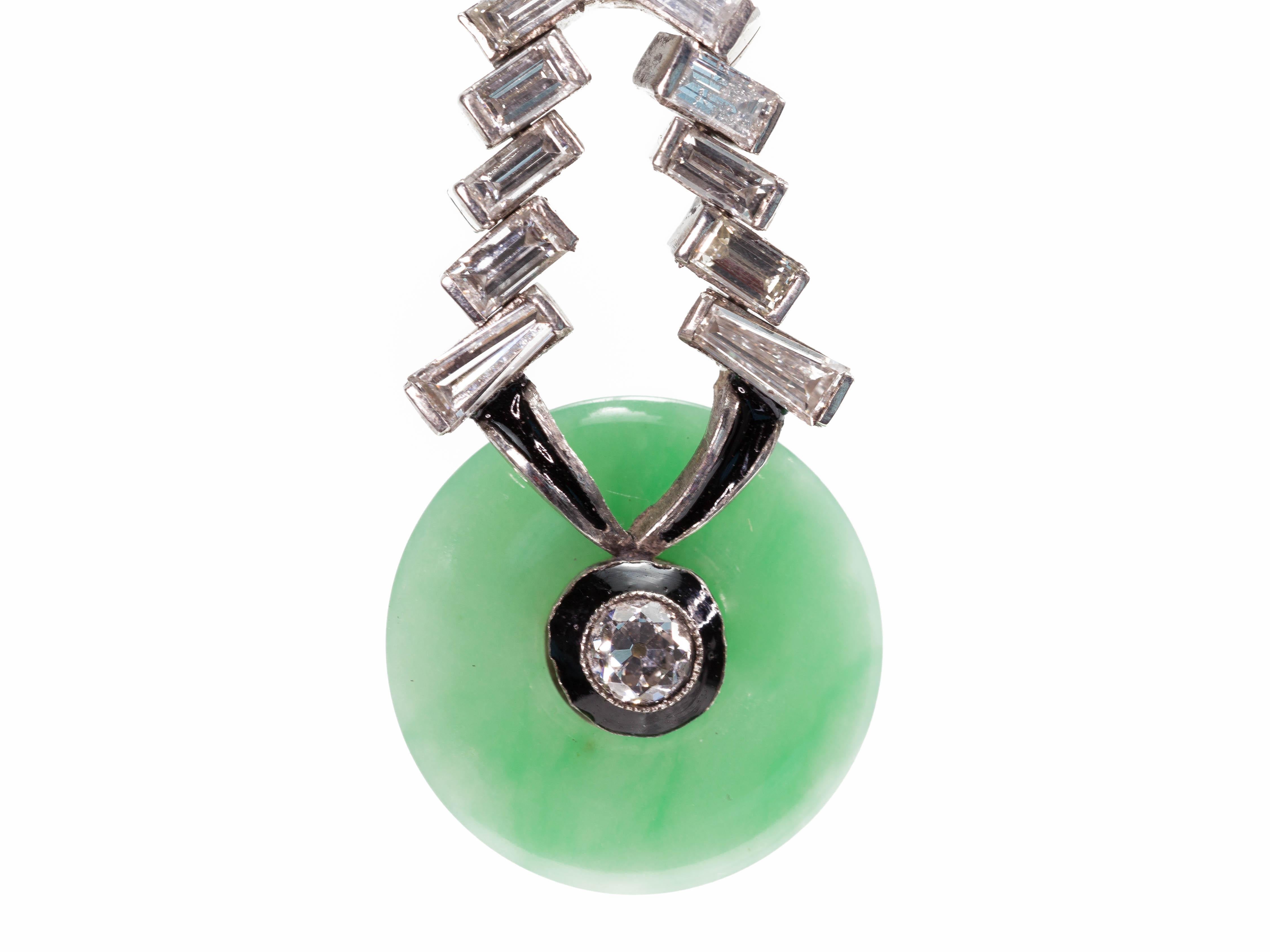 A pair of Italian mid-century natural jadeite Jade and Diamond dangling earrings set in platinum with black enamel accents, circa 1950. Handmade in Italy, this vintage pair of dangling earrings each features a 15.5mm apple green natural jadeite Jade