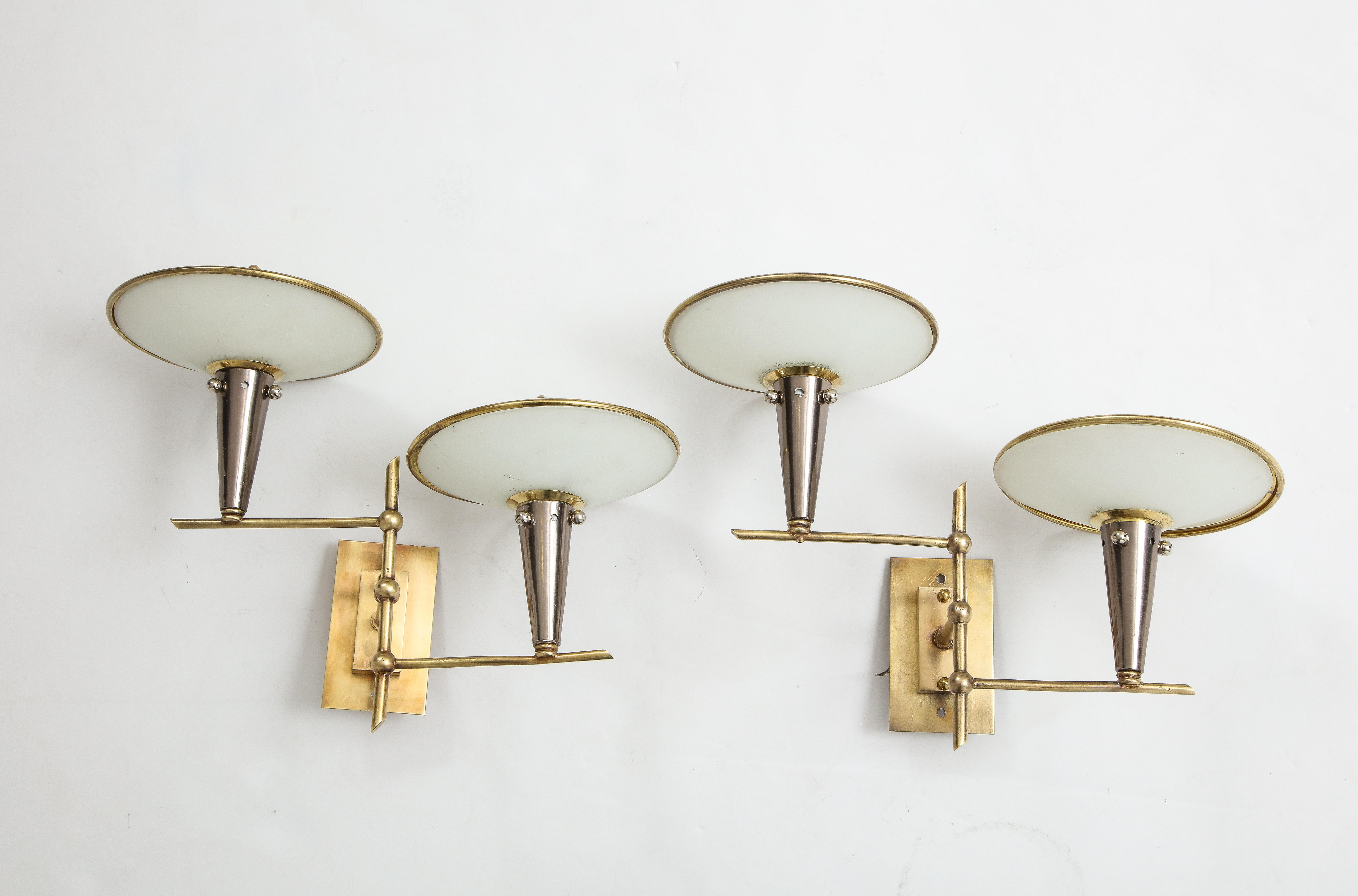 A pair of very unusual and interesting Italian 1950s wall lights. The brass wall plates attach to a vertical brass stem from which two adjustable brass arms extend; with conical shaped nickel supports at either end, below spherical shaped opaline