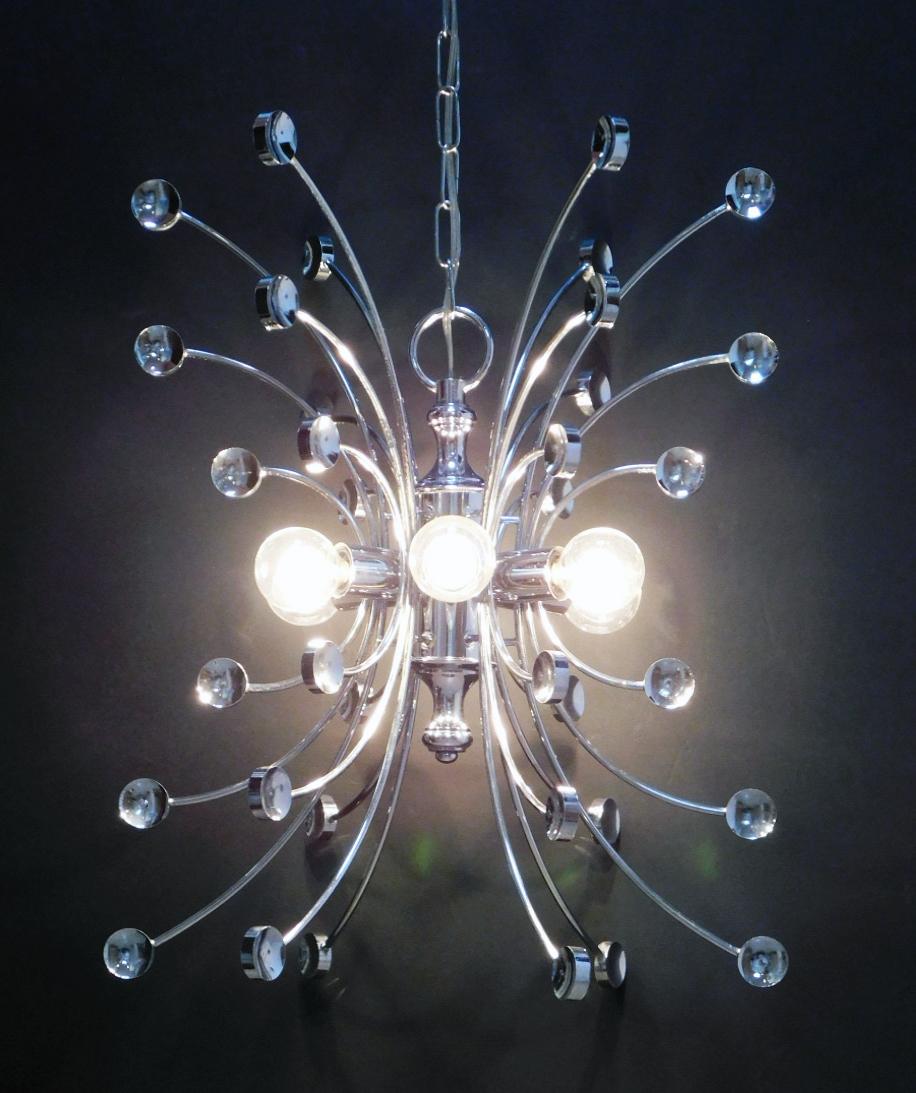 Each of whimsical butterfly form and labeled 'farfalla' having chromed steel frames encircled by six-light and issuing curved arms ending in circular discs.