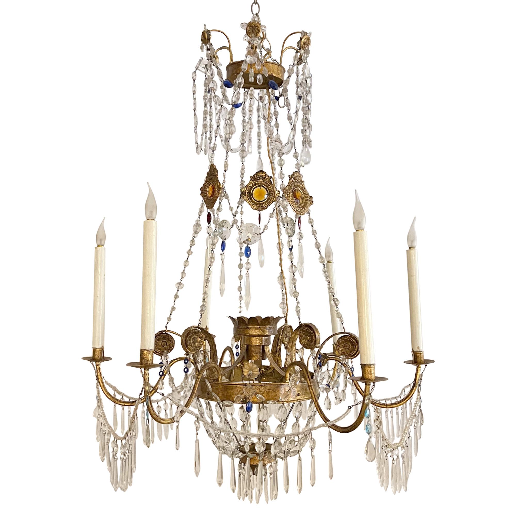 A wonderful pair of highly decorative chandeliers.

Please take a look at all our pictures to see the beading work - including coloured glass, the gilt metal scrolls and gem like glass plaques. 

These lights have been carefully restored and the