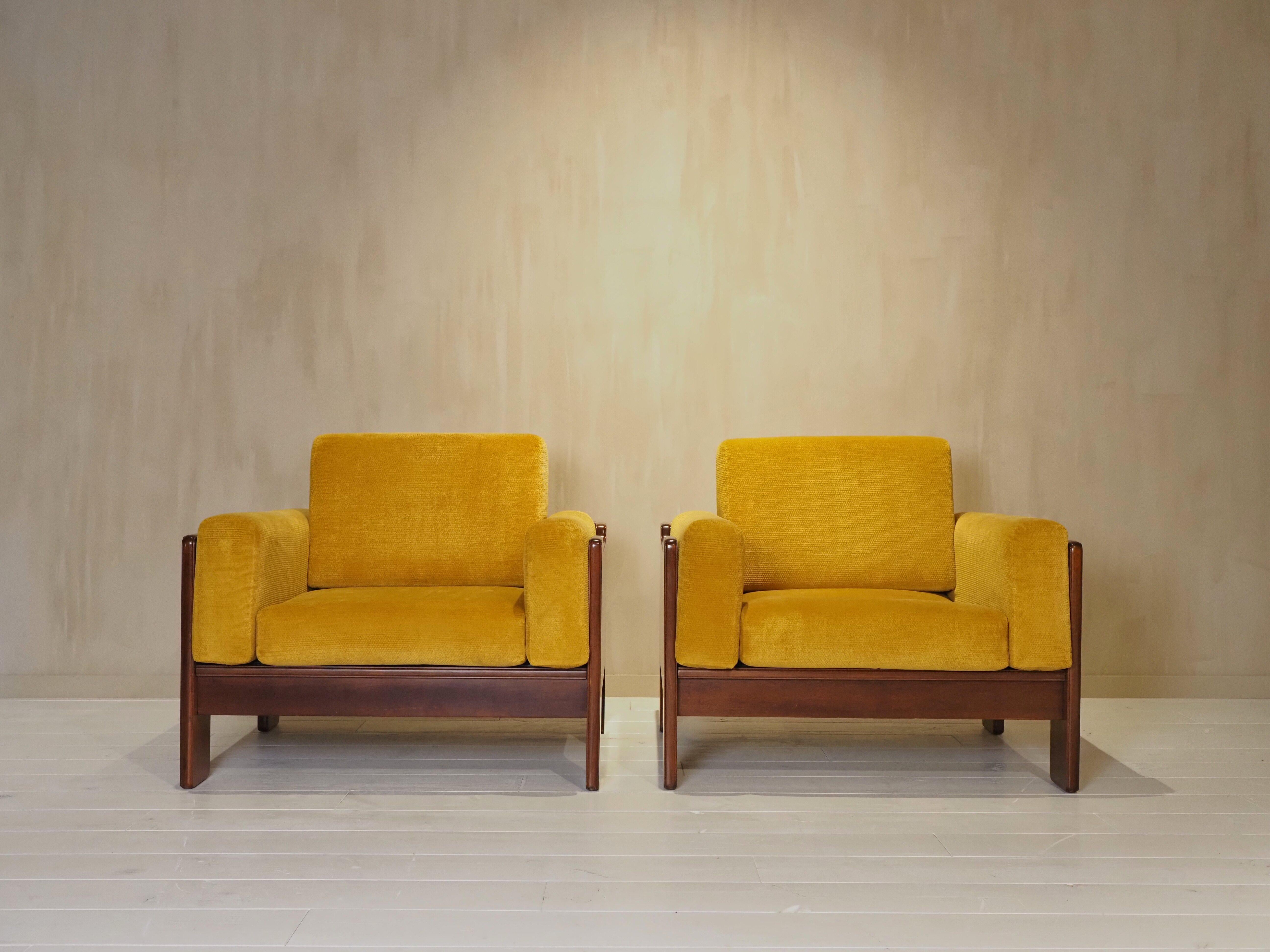 Bring timeless Italian design into your space with this stunning pair of 1970s armchairs. Recently reupholstered in a rich mustard fabric, they combine mid-century elegance with fresh comfort. The solid wooden frames showcase beautiful craftsmanship