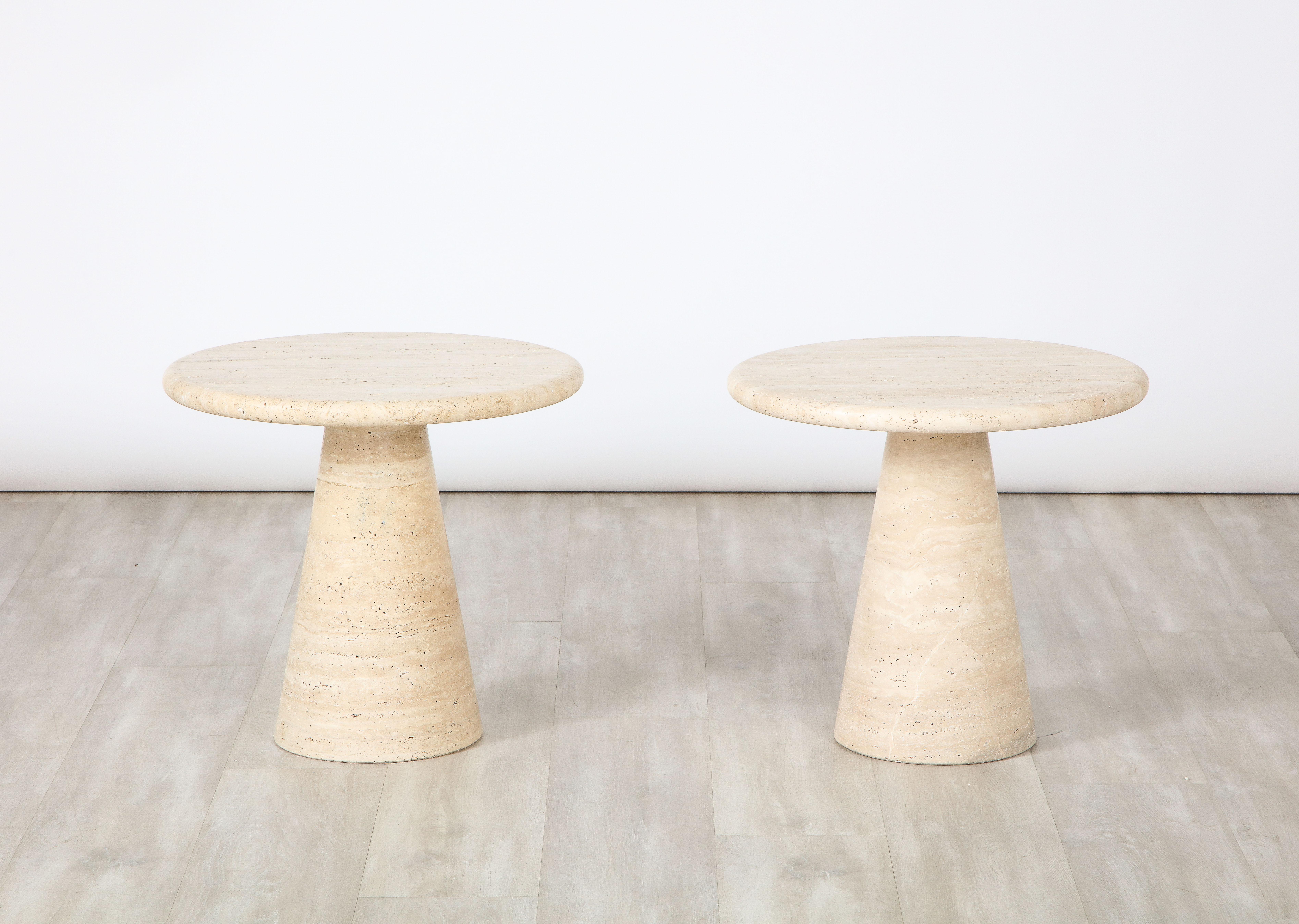 A pair of circular side tables in travertine with a conical shaped base. The form is extremely simple allowing the beauty and variation of the natural stone to take center stage. 
Italy, circa 1970 
Size: 17 3/4