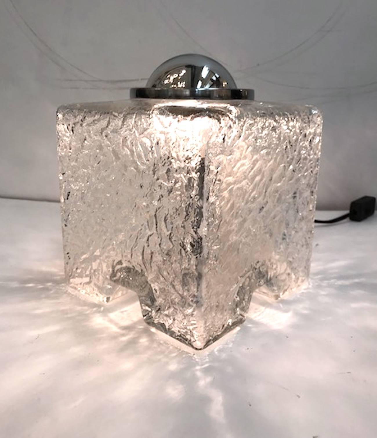 Pure Italian 1970s design is this pair of table lamps. Designed by well know Italian lighting designer Tony Zuccheri for VeArt of Milano. Each is made of textured or mottled glass blown glass cube shades. Each has a chrome base mount and matching