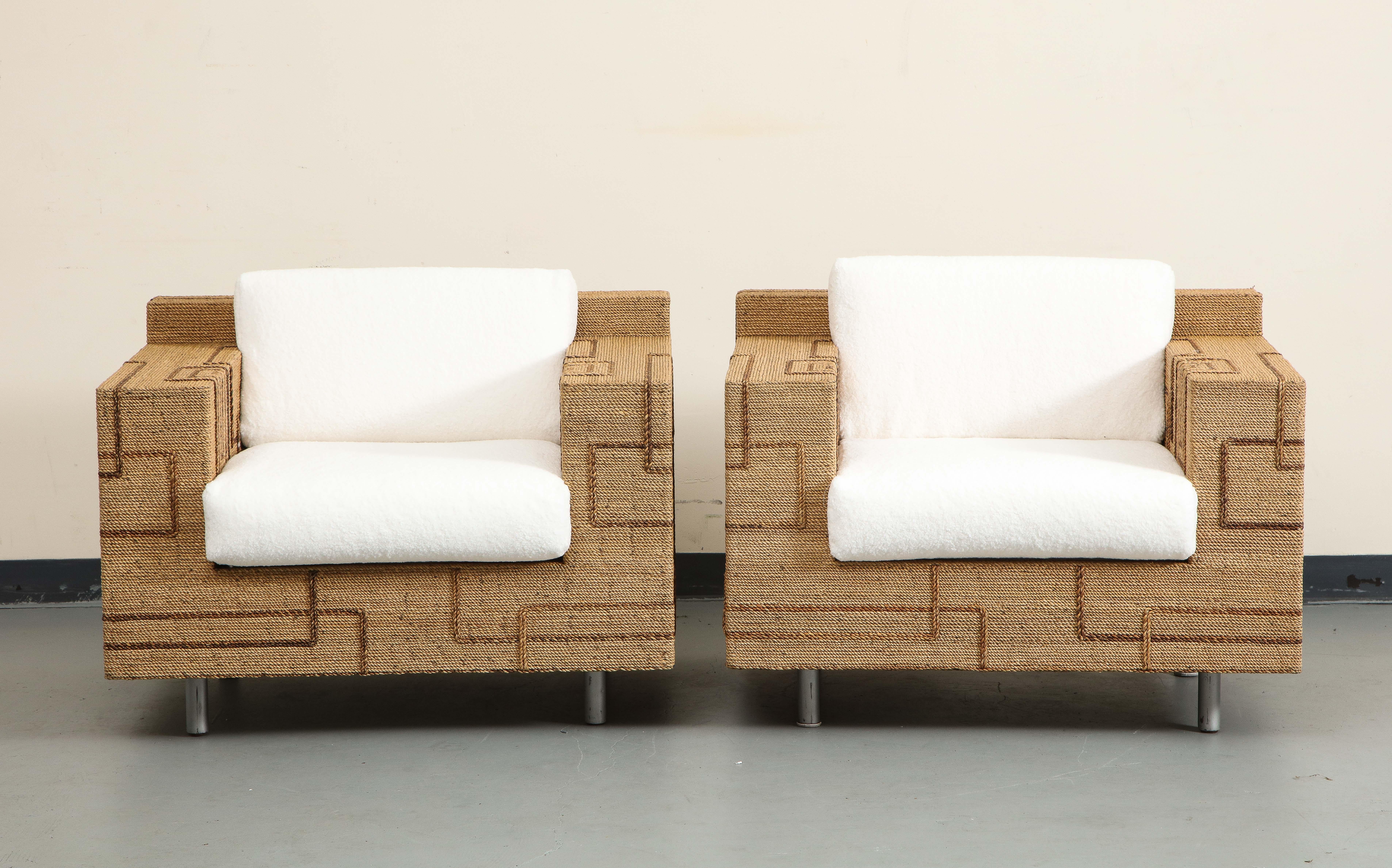 A pair of 1970s Italian rope-inlaid lounge chairs, with geometric line patterns in a contrasting color. Oversize square bases sit firmly on cylindrical metal legs. 

The shearling style cushions are newly made; all-new fill and fabric: Pindler