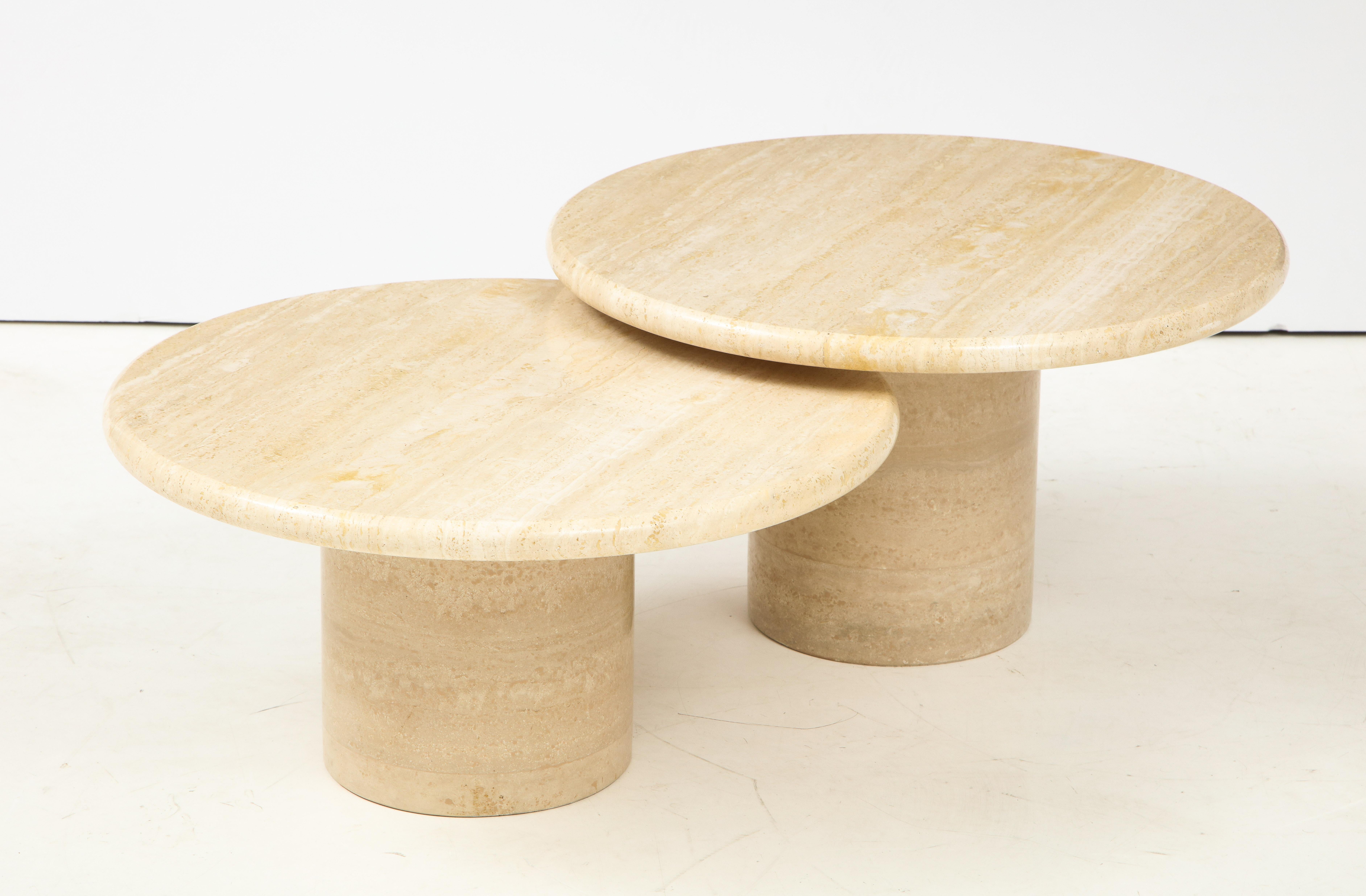 A pair of travertine circular coffee tables; of two heights, the smaller can be set interspersed or next to the larger. 
Italy, circa 1970 
Size: 13 1/2