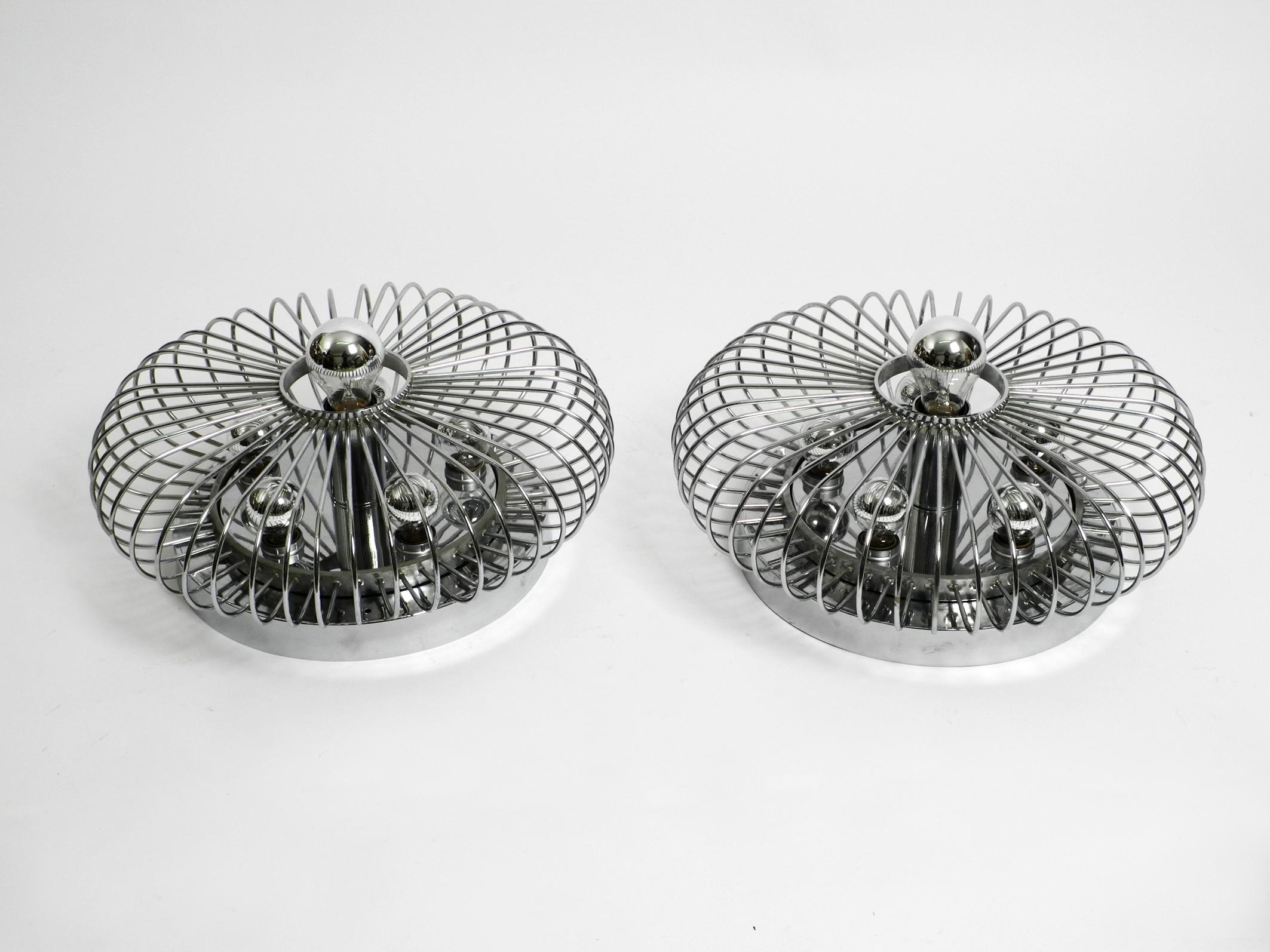 Pair of Italian 1980's large chromed metal ceiling or wall lamps with a spiral design.
Great rare Postmodern design. Made in Italy.
Five E14 sockets and one E27 socket in the middle. 
Sufficient light also for large rooms.
Suitable for ceiling