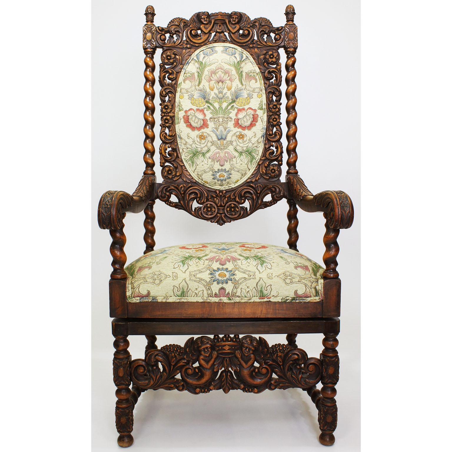 A fine pair of Italian 19th-20th century Baroque Revival style walnut figural carved high-back throne armchairs, each upholstered in a floral cream silk and gold fabric. Please note that these armchairs were recently modified to swivel 360º around,