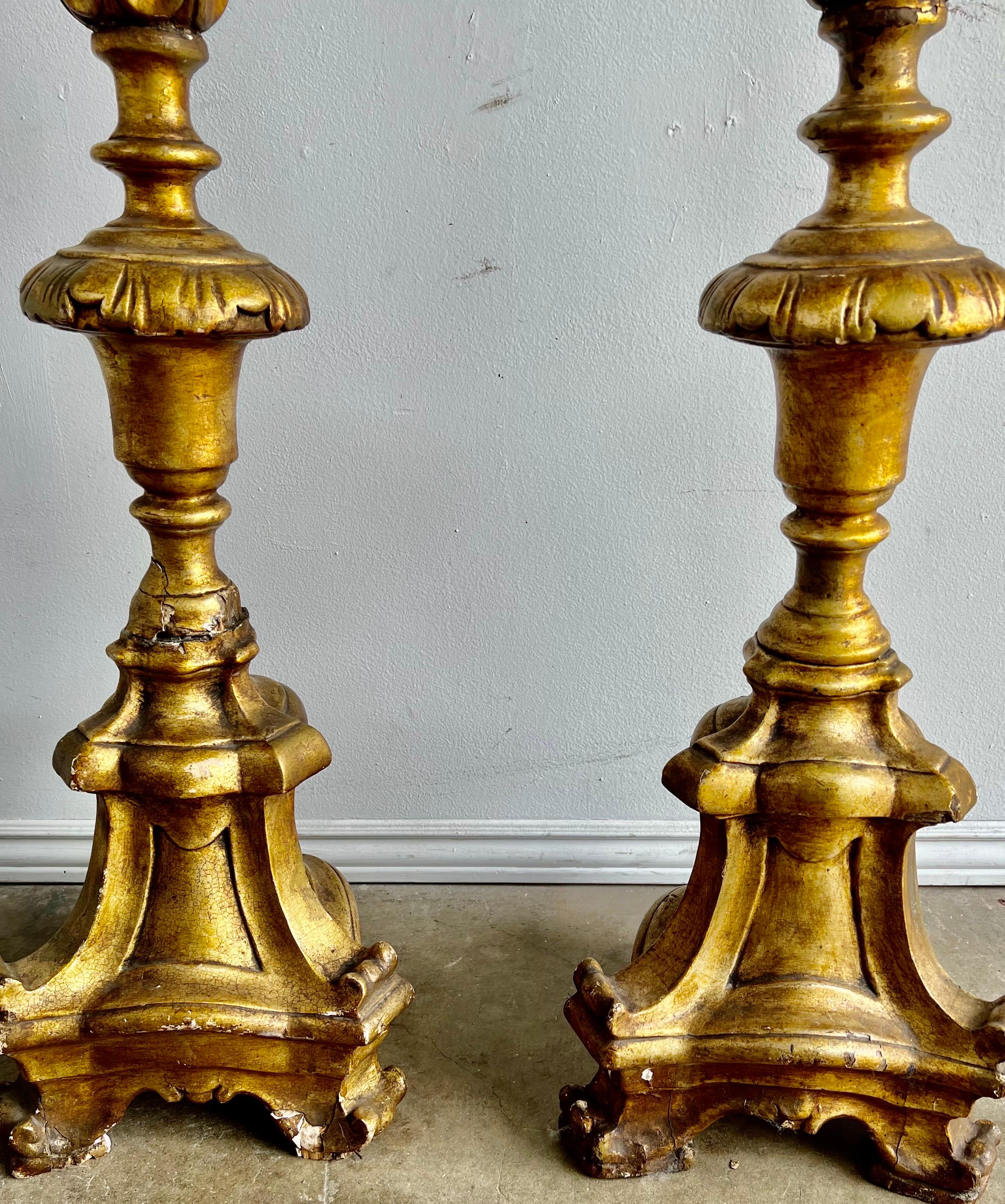 19th C. Italian giltwood candlesticks with iron bobeches and candle prickets.