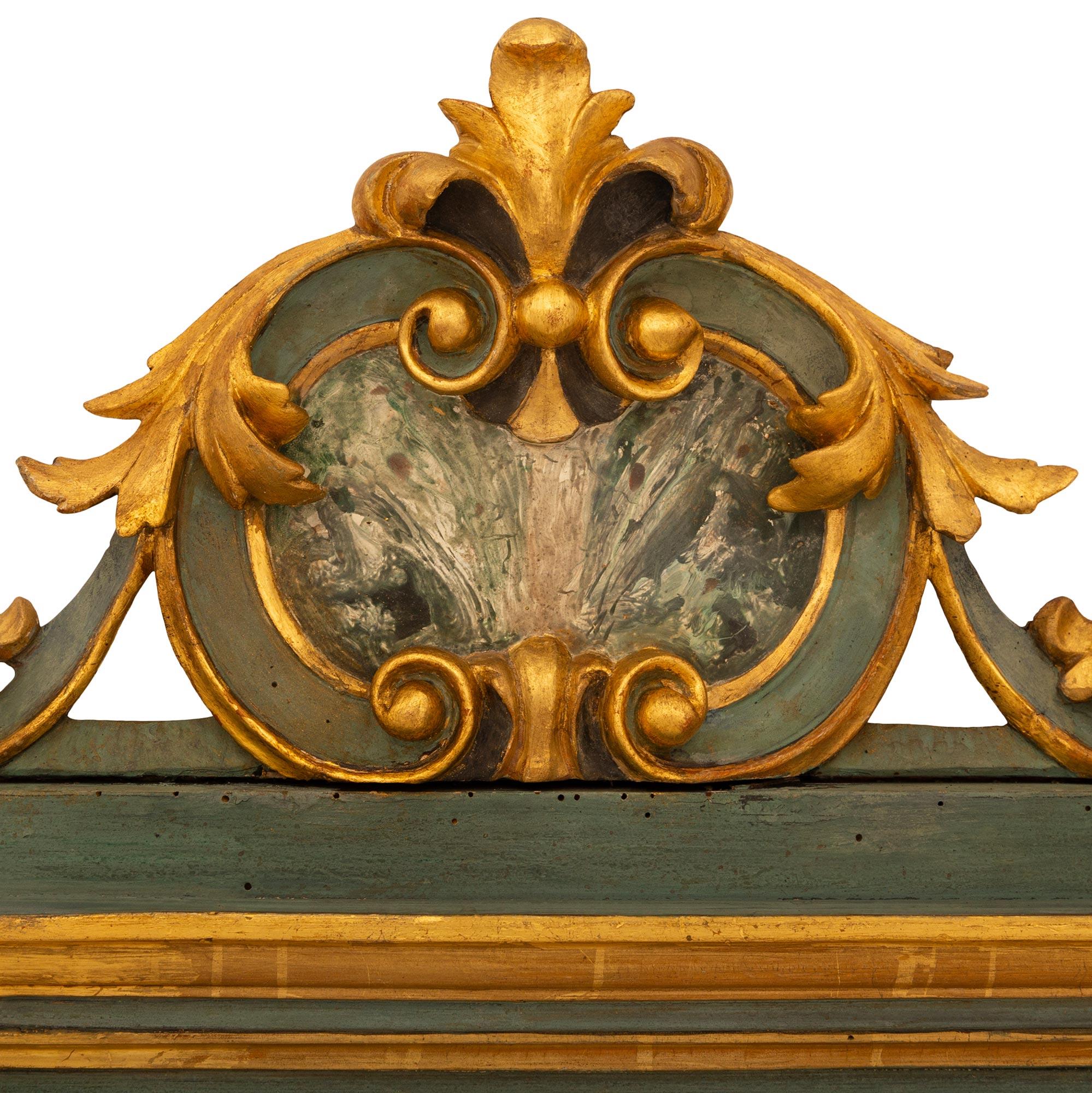 A wonderful pair of Italian 19th century Baroque st. Giltwood and Green Polychrome mirrors. Each unique mirror with its original mirror plate is framed within a square Giltwood frame with mottled edges. The base of each mirror is decorated with
