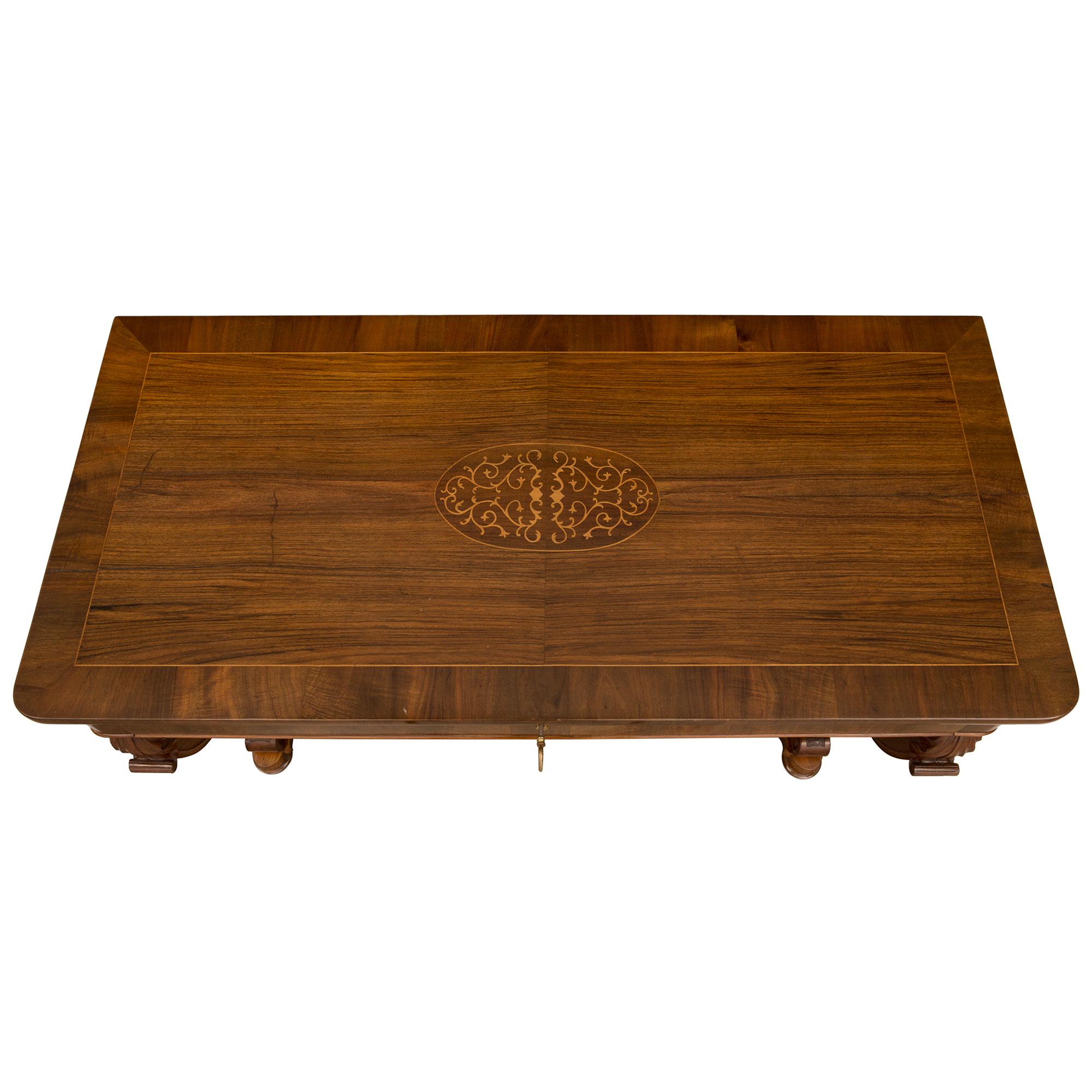 An outstanding and unique pair of Italian 19th century Charles X st. walnut, maple wood and ormolu consoles. Each console is raised by fine bun feet below the elegant veneered bottom tier which showcases the beautiful walnut grain and displays a