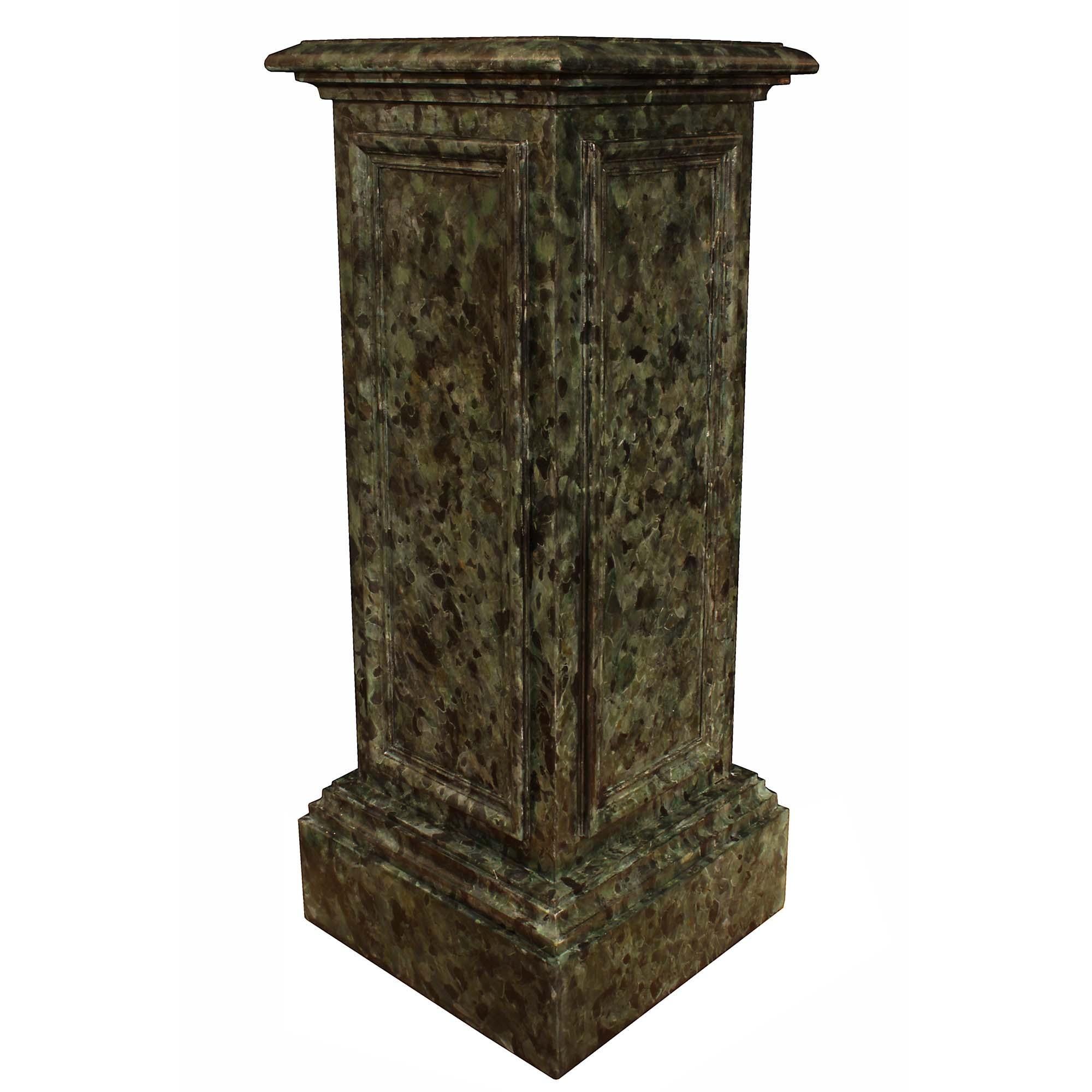 A stunning pair of Italian 19th century classical columns. Each faux marble painted column is raised on a square mottled base. The central body has handsome recessed panels at each side. All below the square mottled solid platform. Extremely
