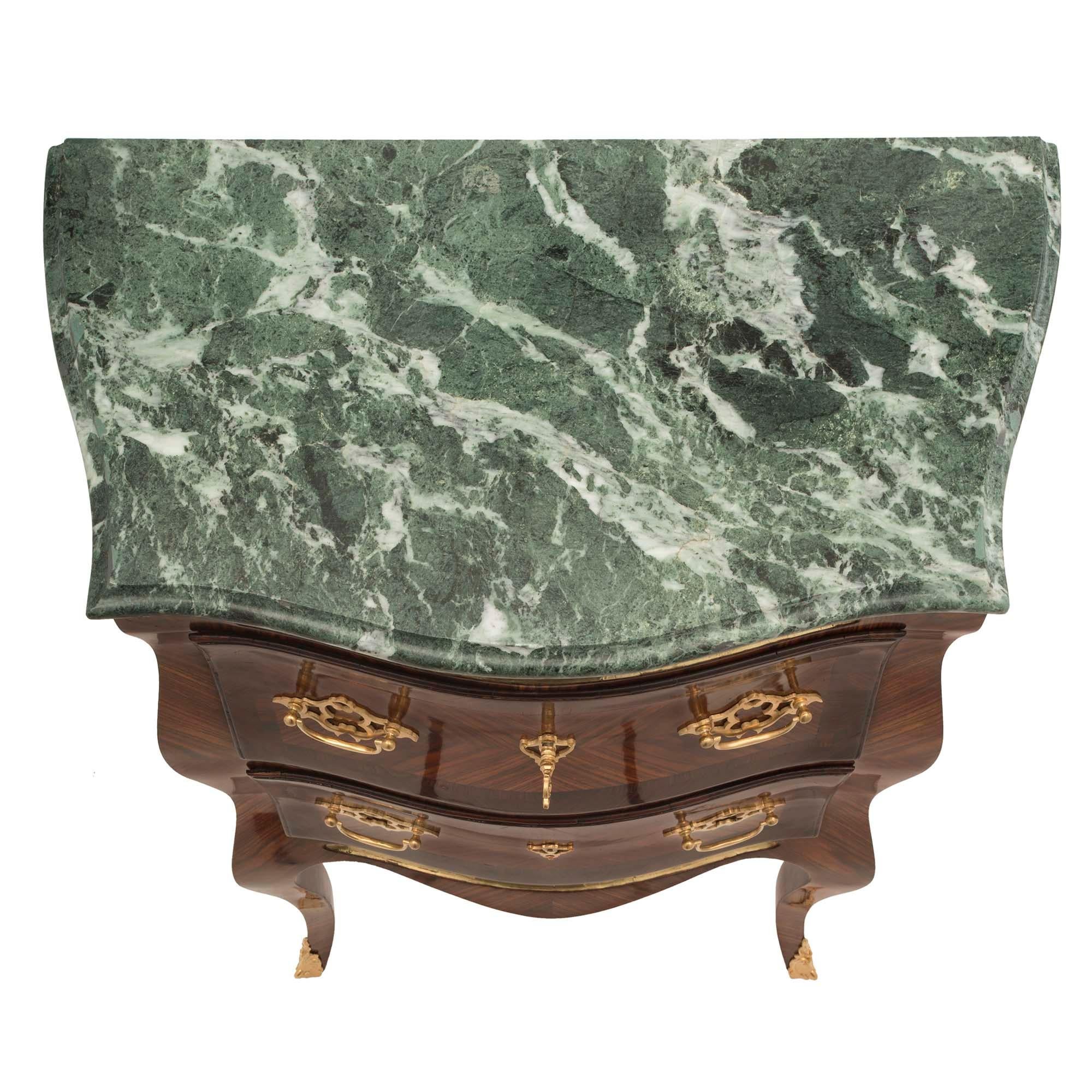 A striking and most unique pair of Italian 19th century Louis XV st. Genovese kingwood and tulipwood bombée shaped side tables. Each quarter veneered side table is raised on cabriole legs with finely chased ormolu sabots. With a scalloped frieze and