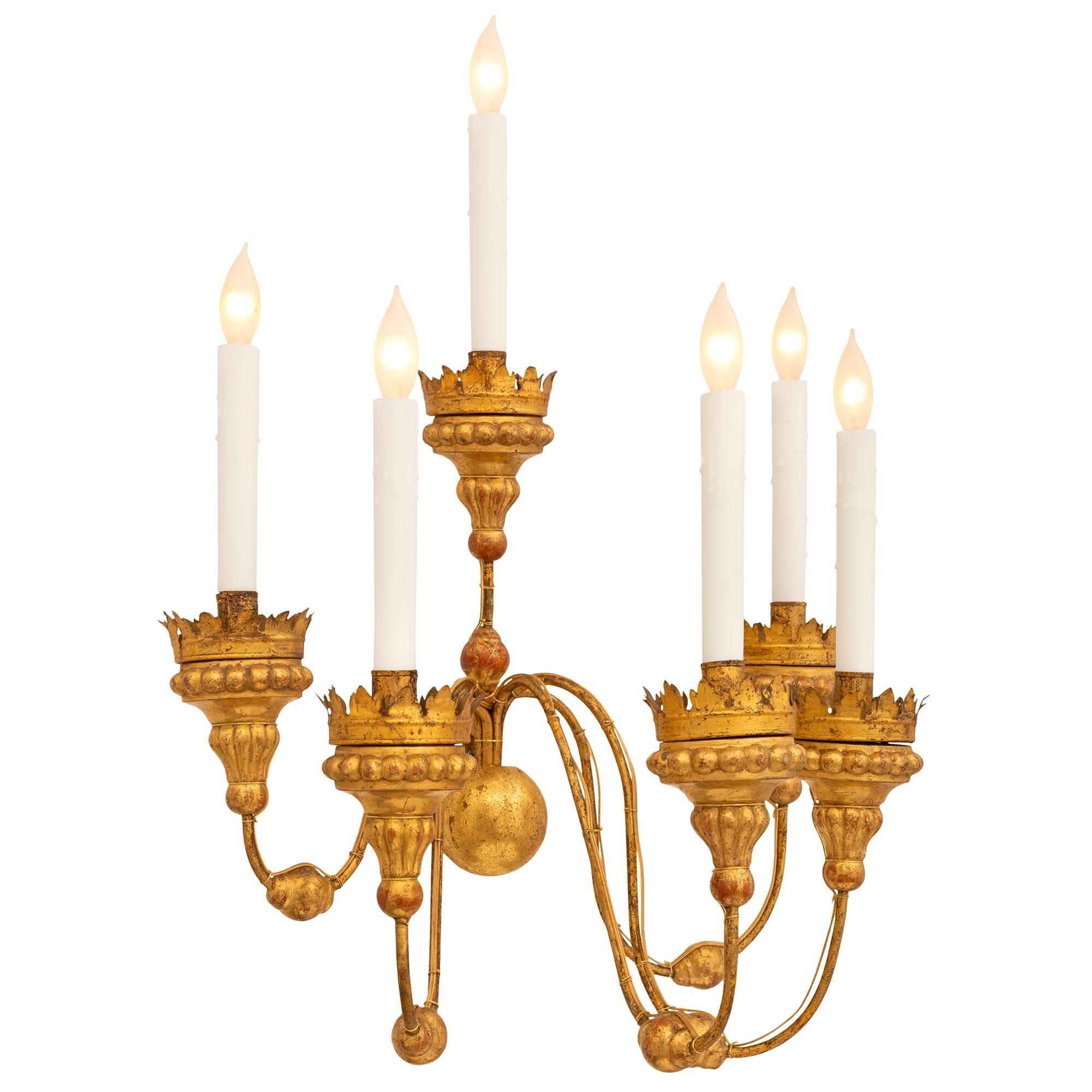 A beautiful pair of Italian 19th century Louis XVI st. Gilt Metal and Giltwood sconces. Each decorative six arm six light sconce is centered by a Giltwood sphere which connects the six 'S' scrolled arms. Each fine round arm contains a circular