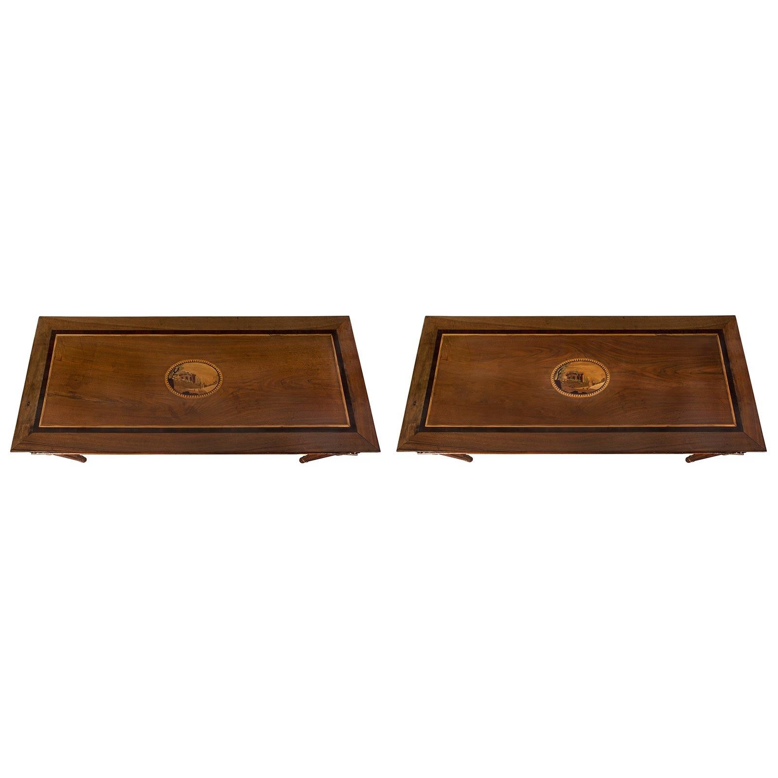 A handsome pair of Italian 19th century Louis XVI st. walnut and exotic wood marquetry Tuscan center/console tables. Each table is raised by circular fluted tapered legs with a top turned mottled band. The straight apron has a bottom mottled trim