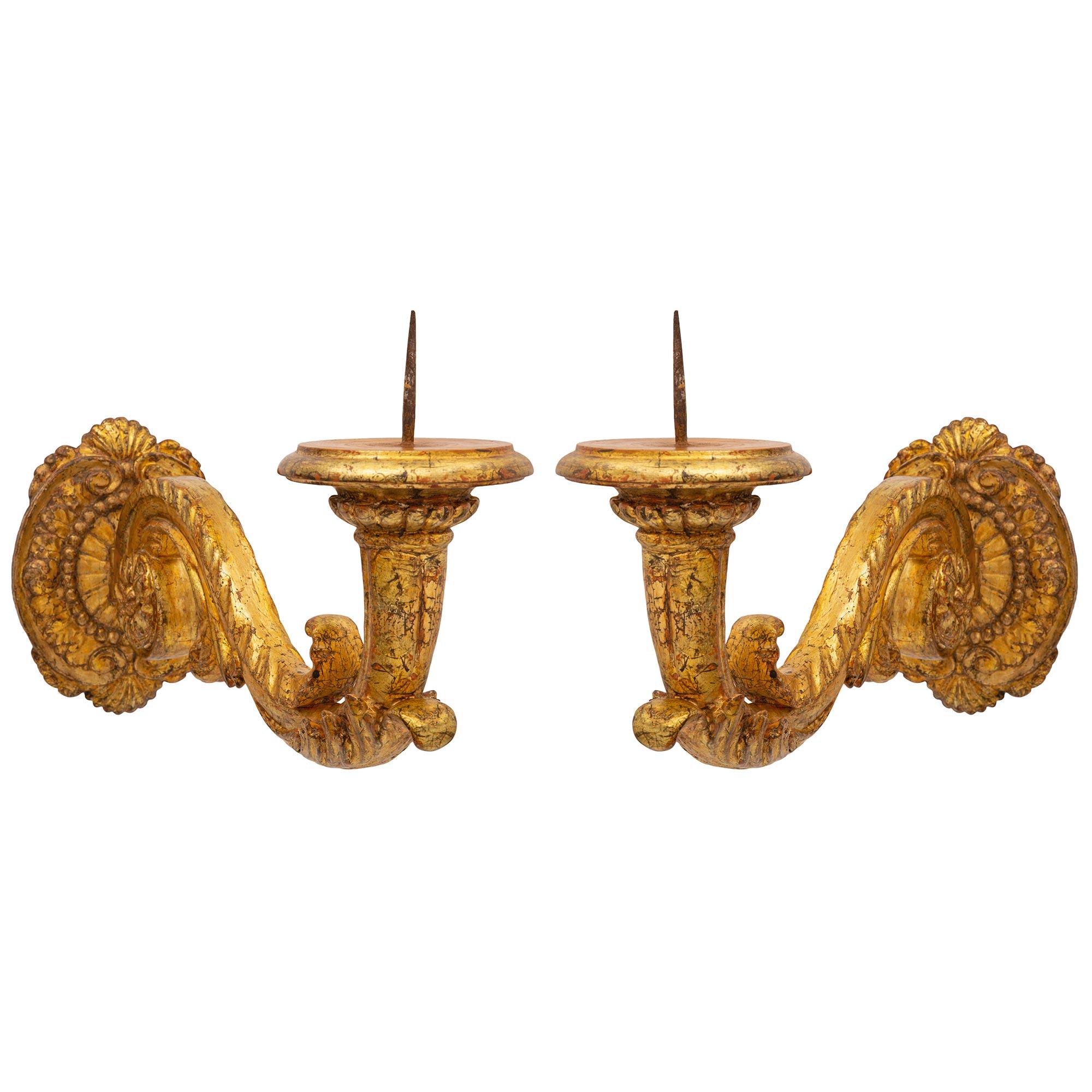 A handsome pair of Italian 19th century mecca bras de lumière sconces. Each impressive Bras de Lumière sconce is centered by a beautiful foliate backplate with lovely seashell reserves and a fine wrap around band. The elegantly scrolled arms are