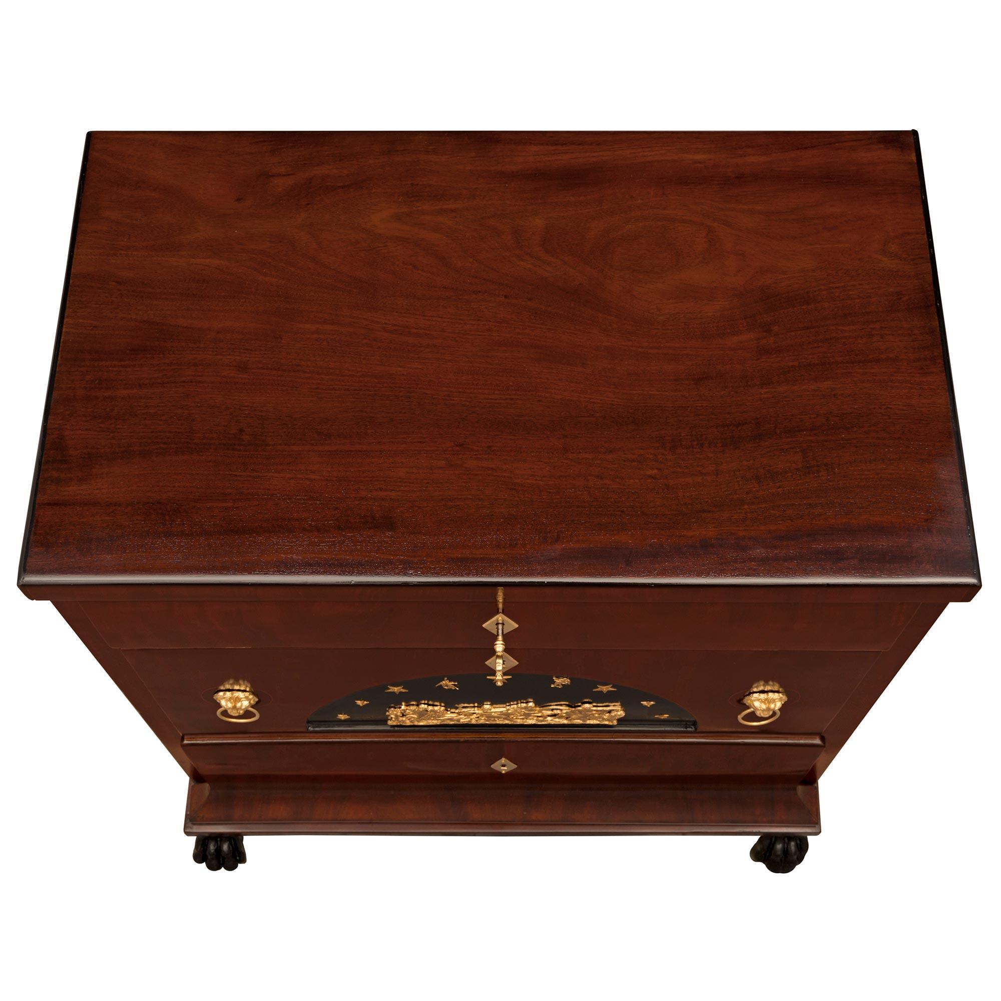 A sensational and extremely decorative pair of Italian 19th century Neo-Classical st. flamed Mahogany, Maplewood, Olivewood ebonized Fruitwood and ormolu chests. The his and hers pair of three drawer chests are raised by handsome richly carved paw