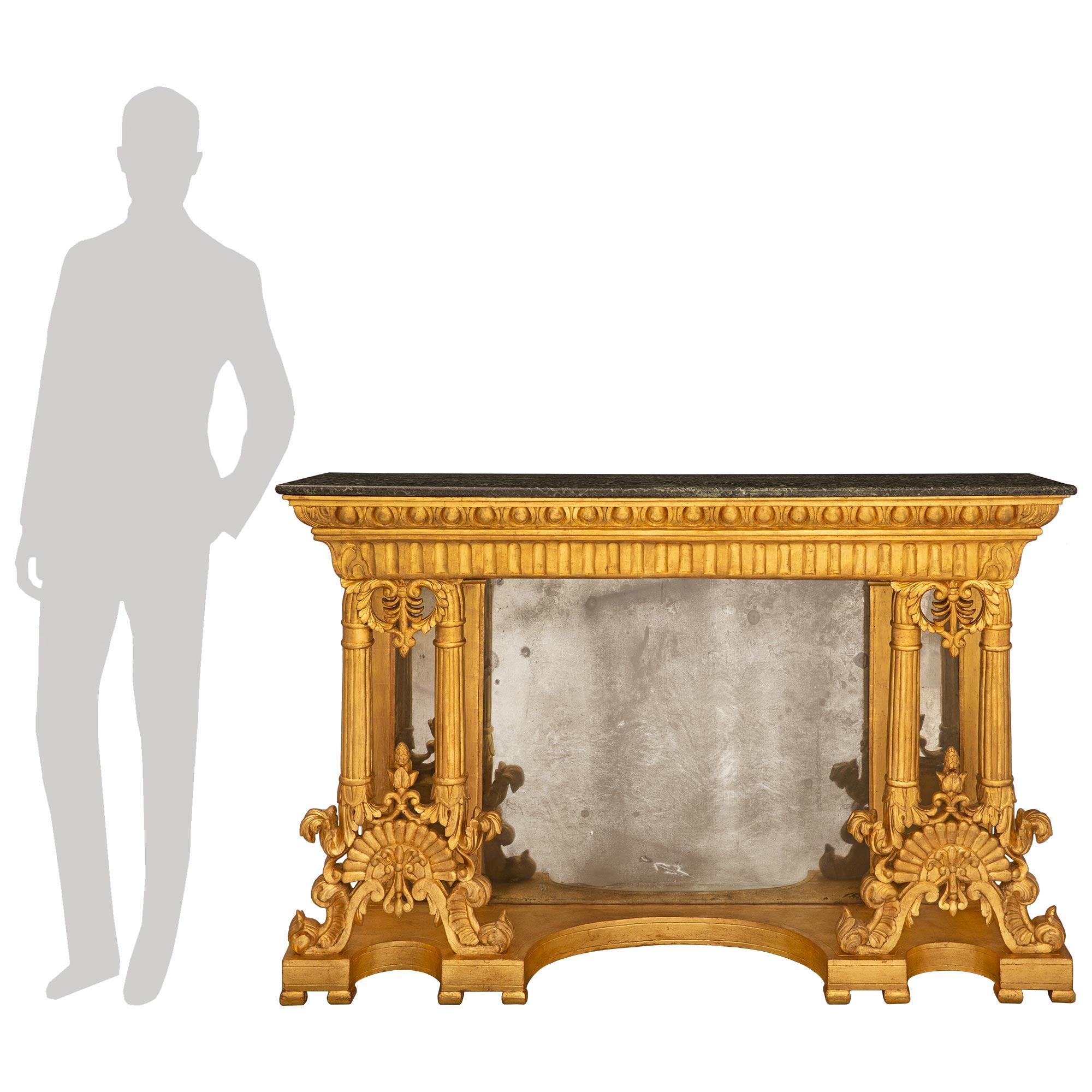 An impressive pair of Italian 19th century Neo-Classical st. giltwood and Rosso Levanto marble mirrored consoles. Each console is raised by fine topie feet below the decorative bottom tier with beautiful curved designs and delicate fillets with