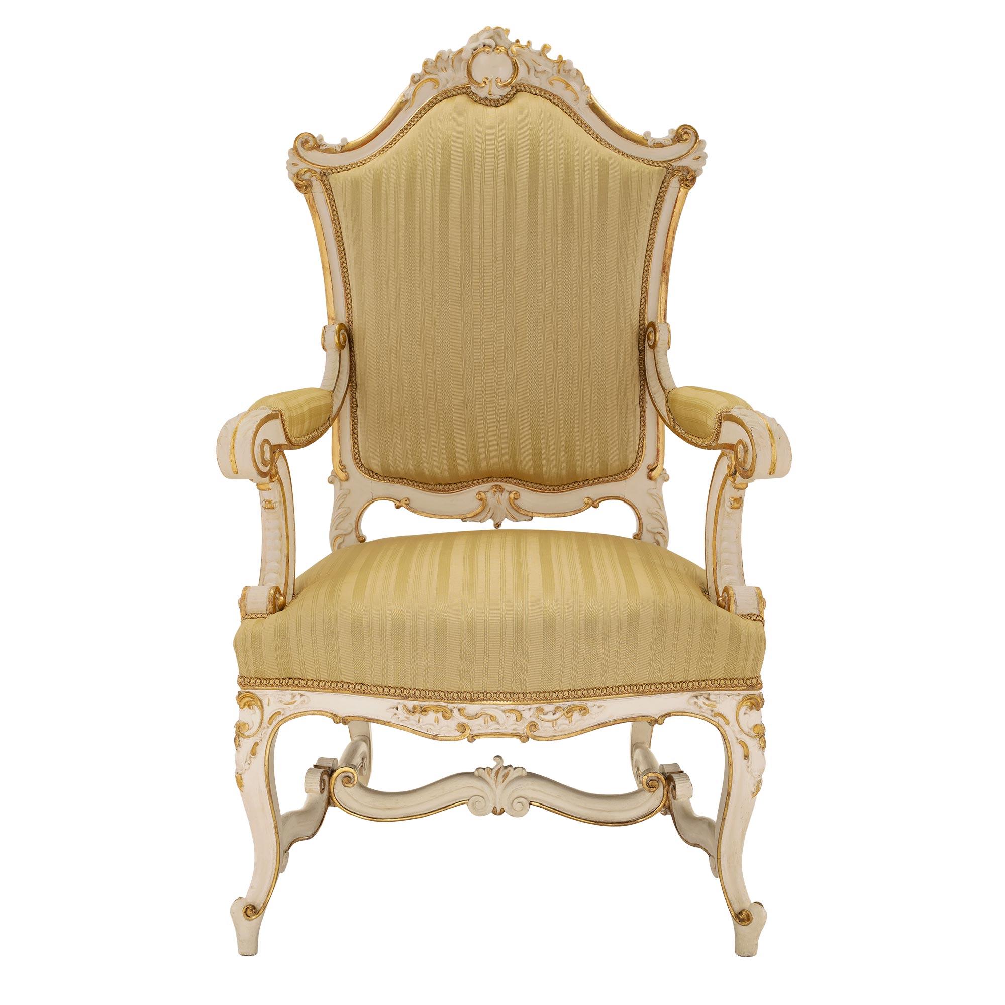 A beautiful and high quality pair of Italian 19th century patinated and giltwood Venetian armchairs. Each armchair is raised by elegant cabriole legs, attached by a scrolled H shaped stretcher with wonderfully decorative movements and giltwood