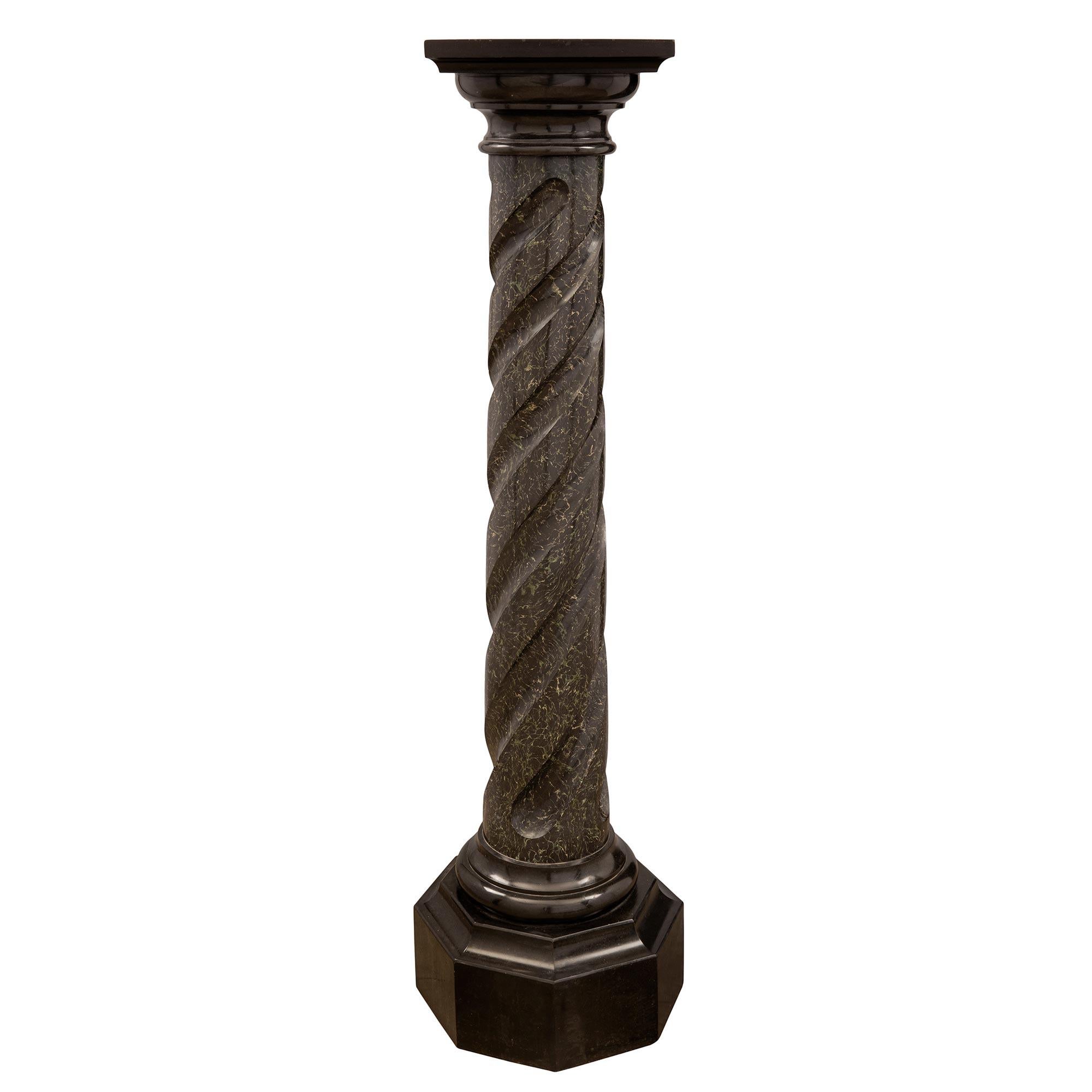 A fine pair of Italian 19th century Louis XVI st. Scagliola and Black Belgian marble columns. Each column is raised by a octagonal Black Belgian marble base below elegant mottled socle pedestals. The circular Scagliola central supports display