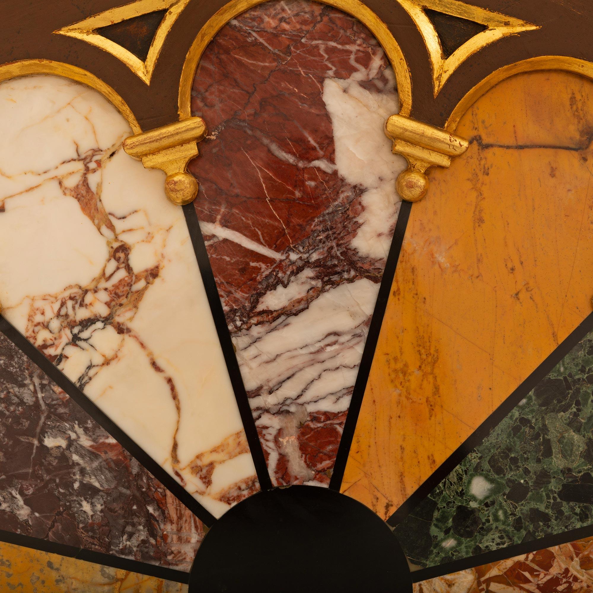 An attractive and unique pair of Italian 19th century patinated wood, Giltwood, specimen marble and semi-precious stone wall decor/panels. Each half round panel displays a variety of seven different marbles which are fitted within a patinated brown