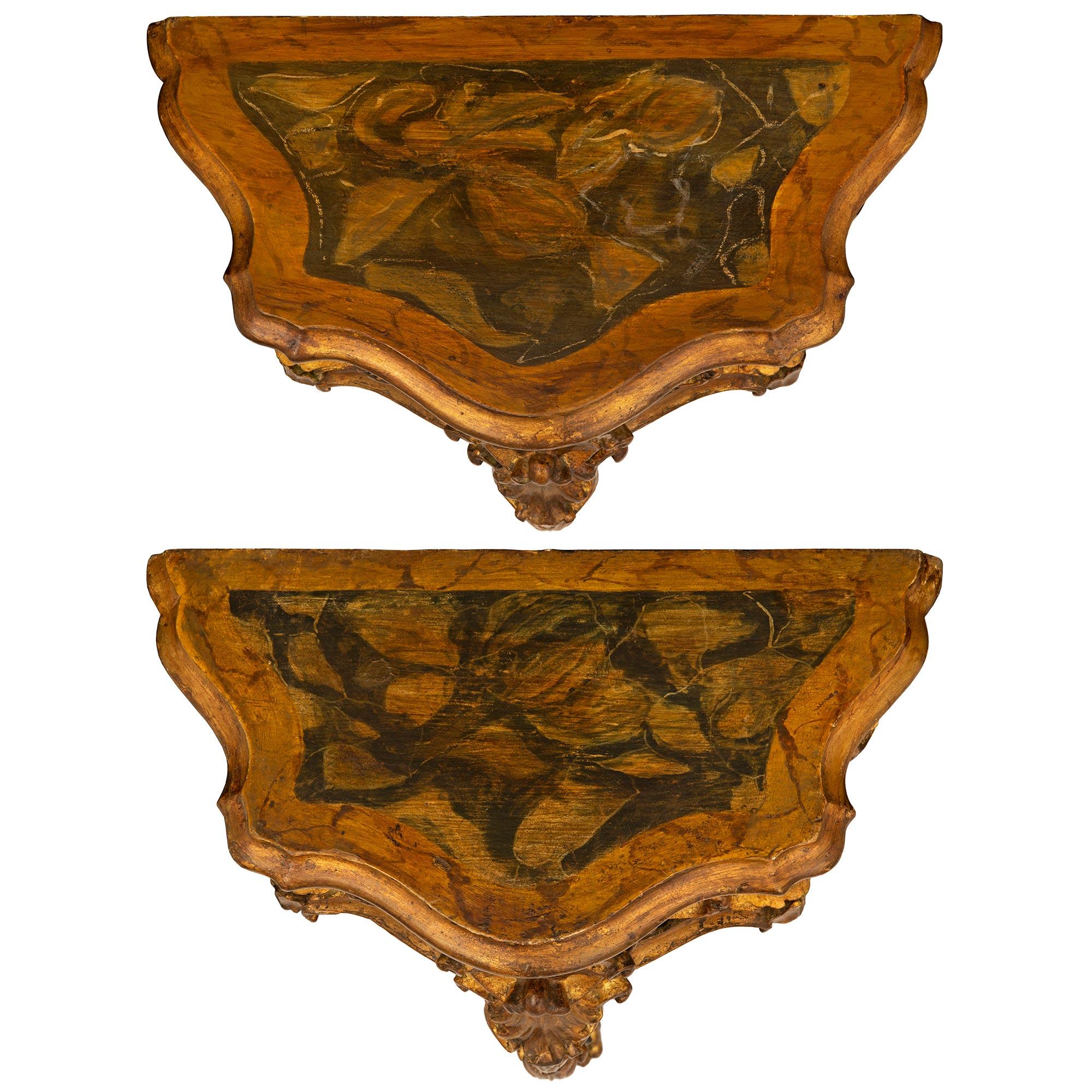 A beautiful and most decorative pair of Italian 19th century Venetian st. Mecca, polychrome and faux painted marble consoles. Each wall mounted console is raised by an elegantly scrolled single central leg with a handsome richly carved paw foot and